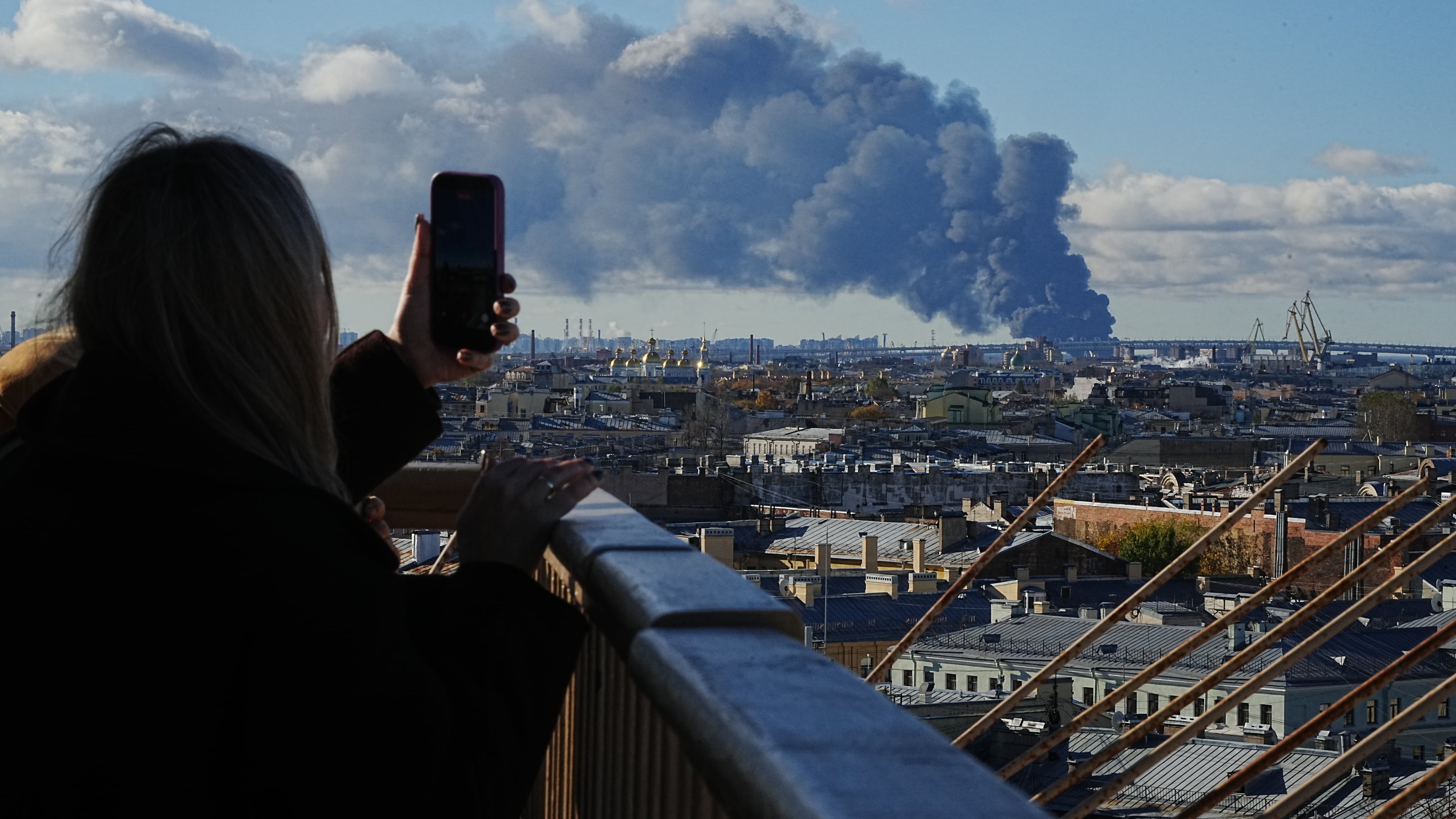 Smoke billows into the sky following Ukrainian drone strikes on an industrial zone in St. Petersburg, Russia, on Sunday, Oct. 18, 2026. (UGC via AP)