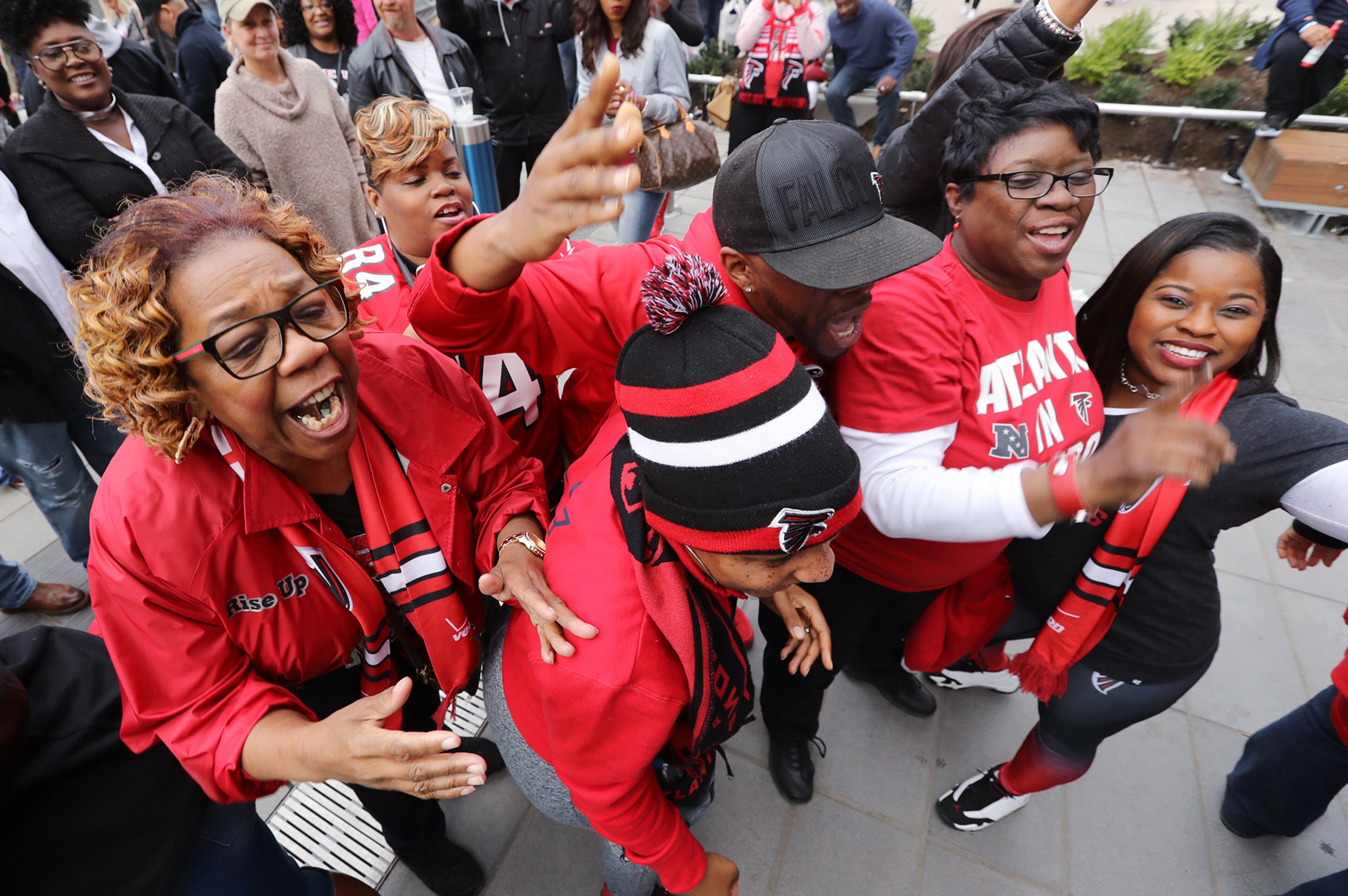 February 4, 2017, Houston: Mary McGraw (from left), Chaunecey and Everett Richrds, and Mescal Hunt, from Atlanta, get rowdy the night before the Super Bowl while taking in the NFL Experience and Super Bowl Live on Saturday Feb. 4, 2017, in Houston. McGraw said sheâs been a Falcons fan her whole life. Curtis Compton/ccompton@ajc.com