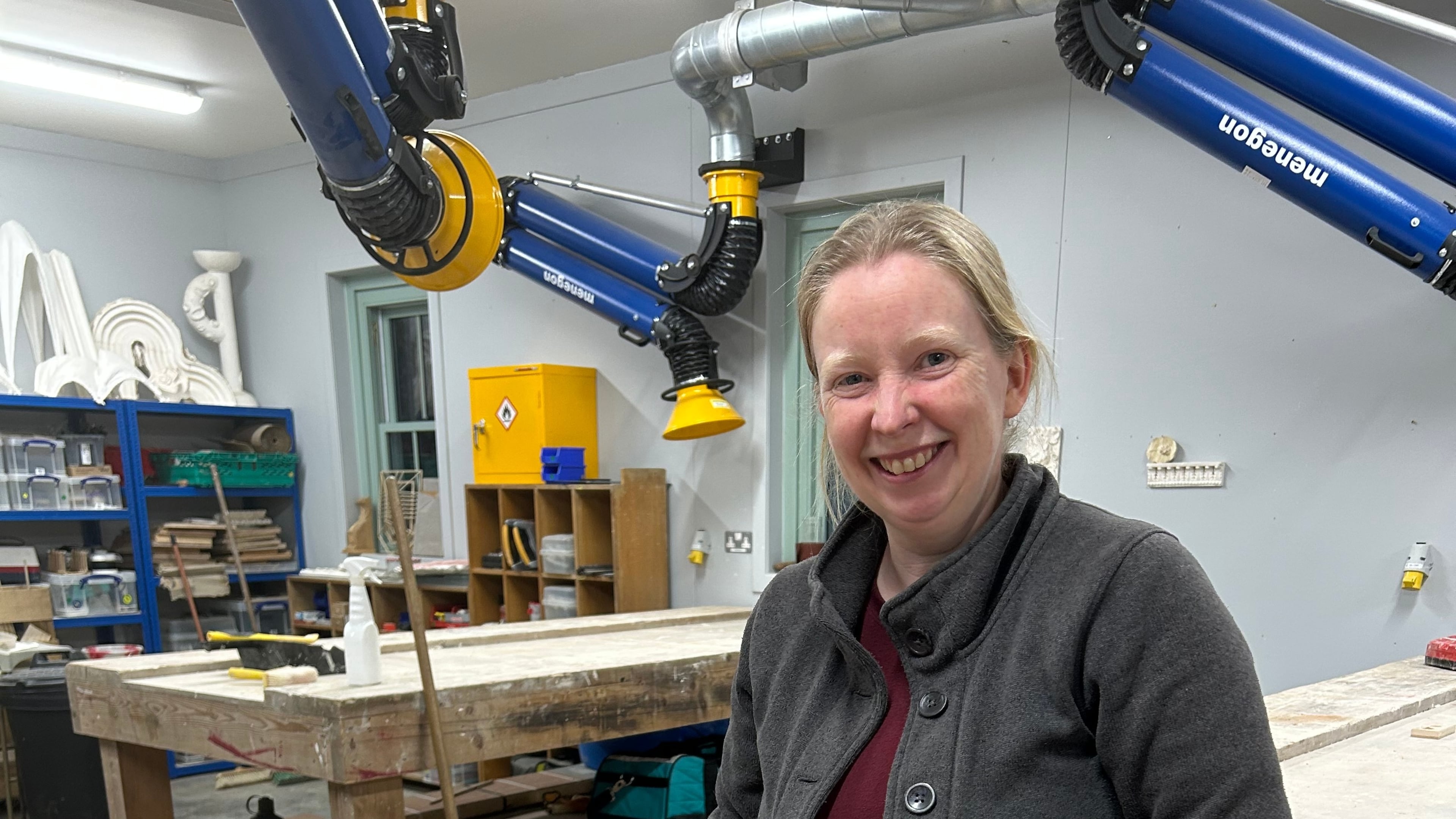 Jennie Regan stands beside the stone she carved with an inscription from a Scottish fairy tale at Dumfries House in Cumnock, Scotland, Nov. 26, 2025. (AP Photo/Danica Kirka)