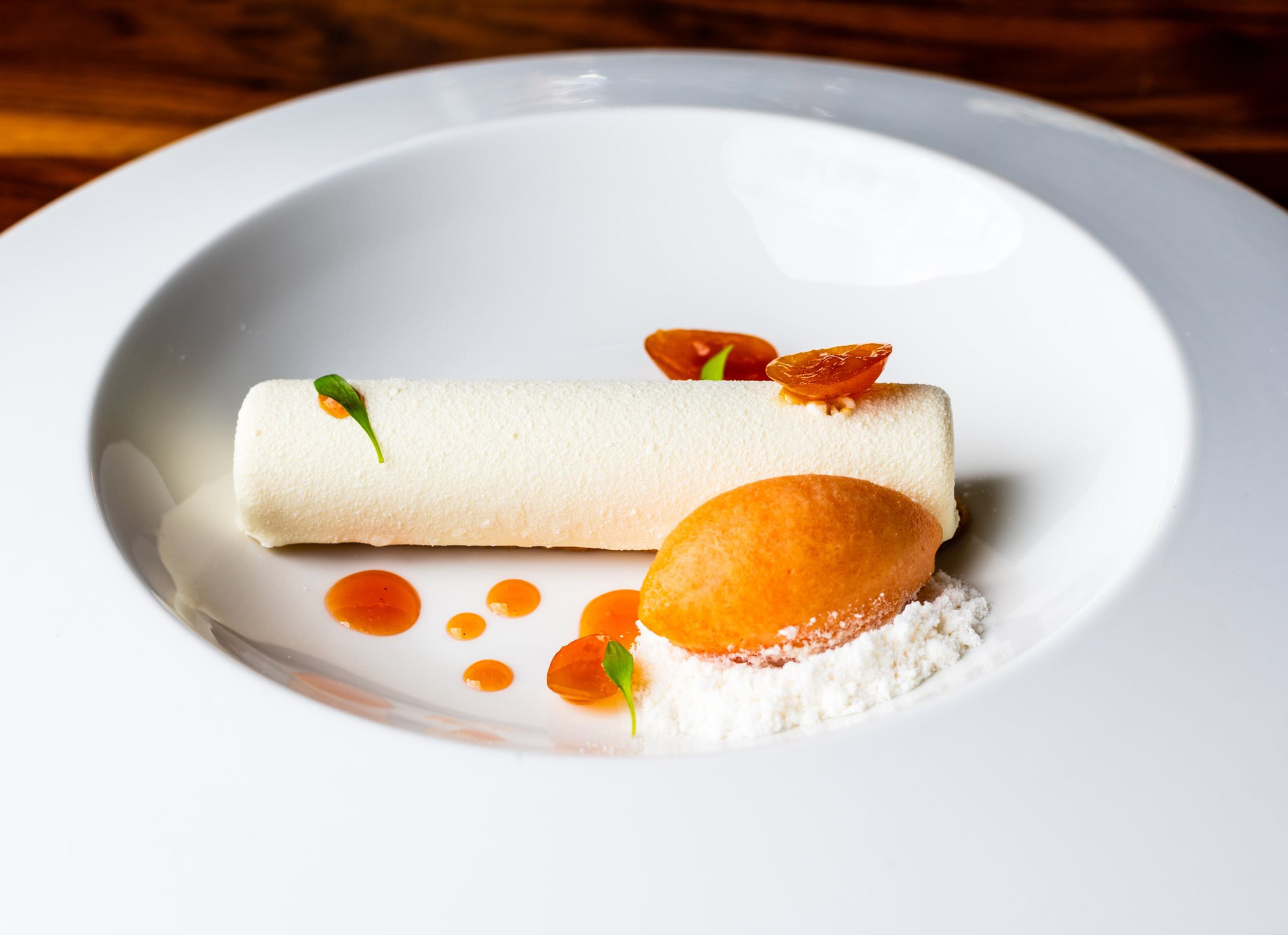 In the Creamsicle from Lazy Betty, a vanilla semifreddo is encased in a white chocolate shell and placed over a narrow sweet biscuit, and it comes with blood orange sorbet and orbs of kumquat gelee. CONTRIBUTED BY HENRI HOLLIS