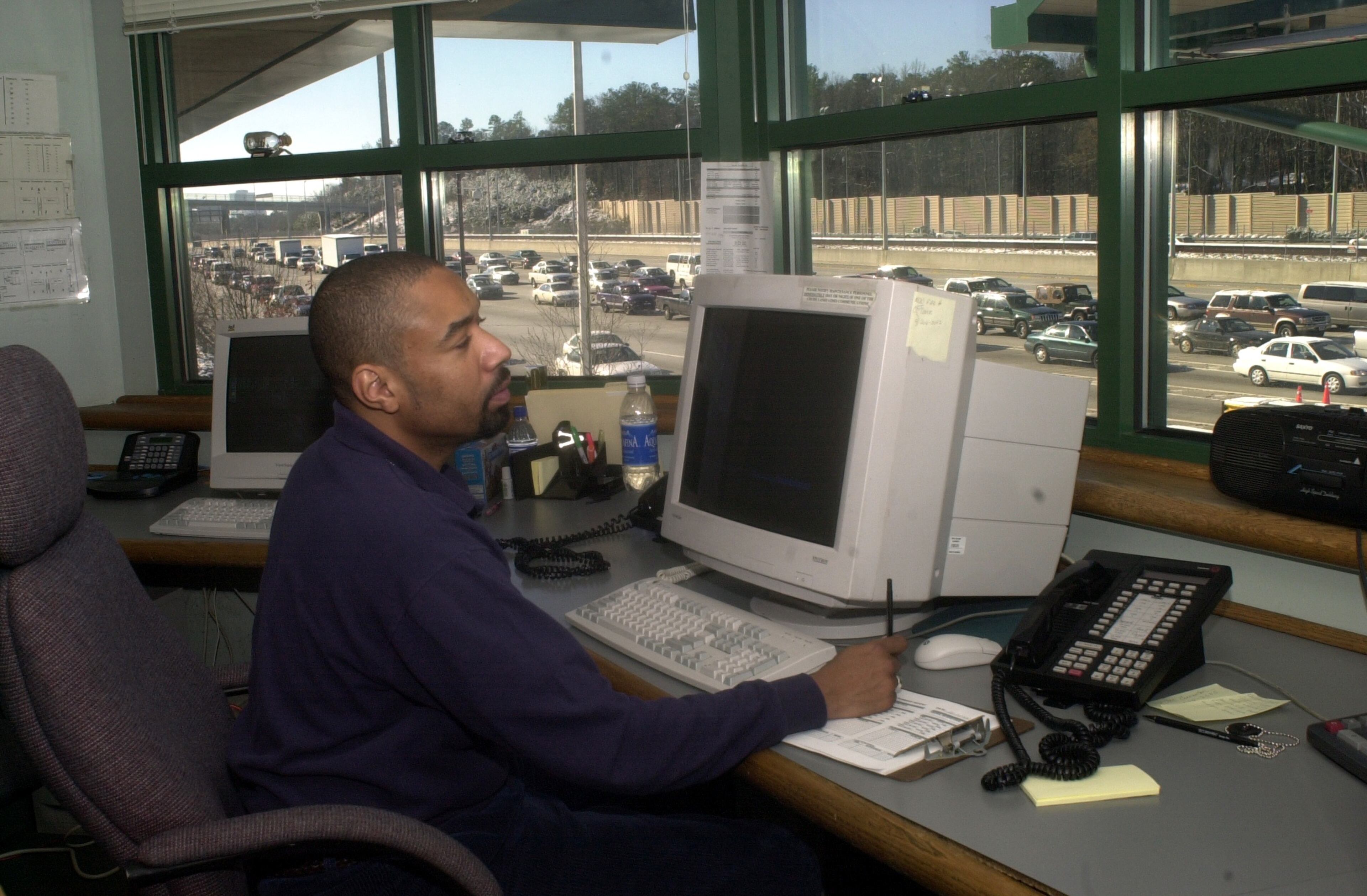 Photos shot in the control booth at the toll plaza on GA 400 northbound for story about the operations of North Georgia's only toll road. Gregory Walker (CQ), assistant toll collection supervisor, coordinates lane operations (monitors lanes and processes violations). (CHARLOTTE B. TEAGLE/Staff)