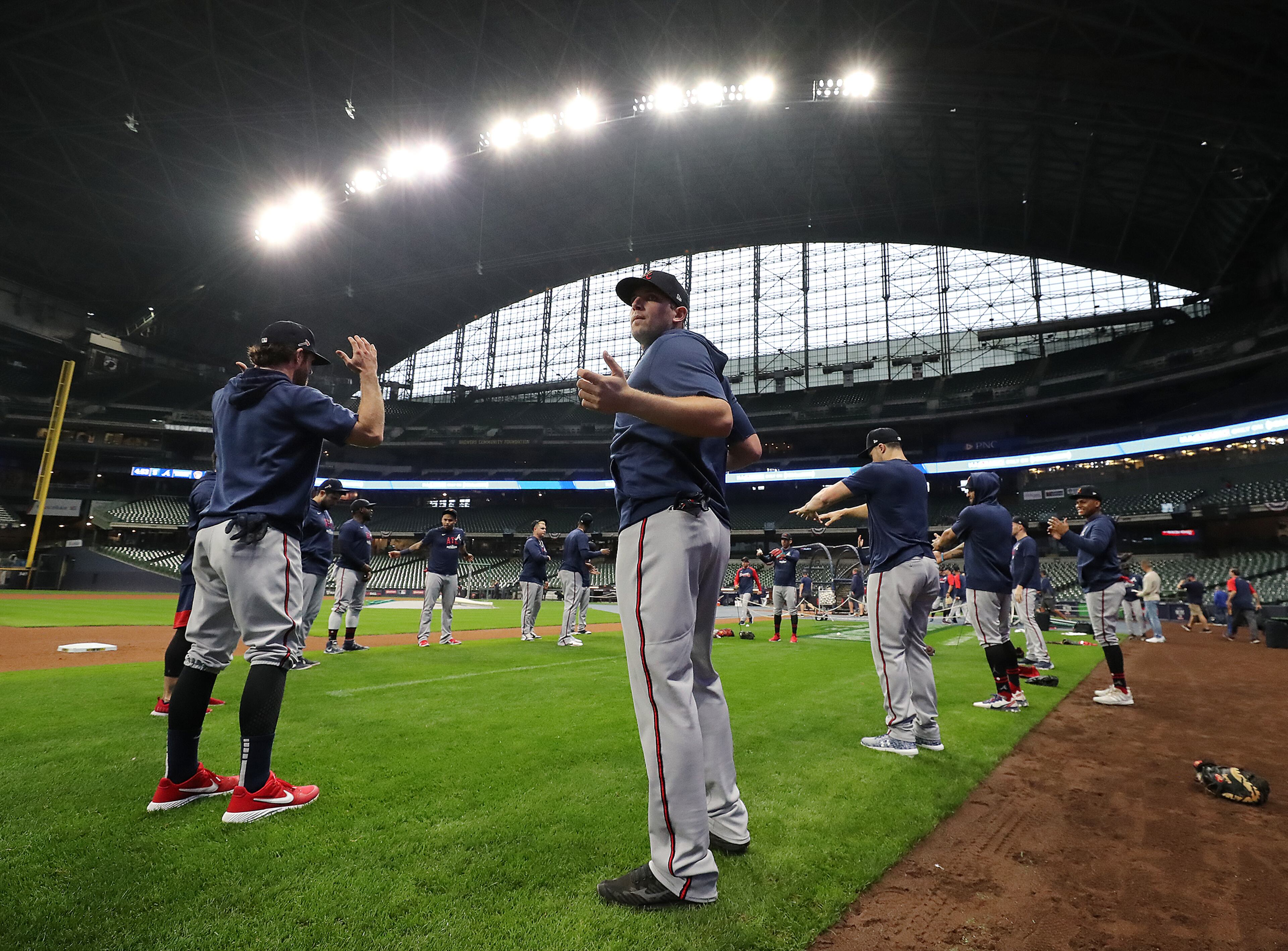 Braves third baseman Austin Riley (center) takes in the stadium as the team loosens up. “Curtis Compton / Curtis.Compton@ajc.com”