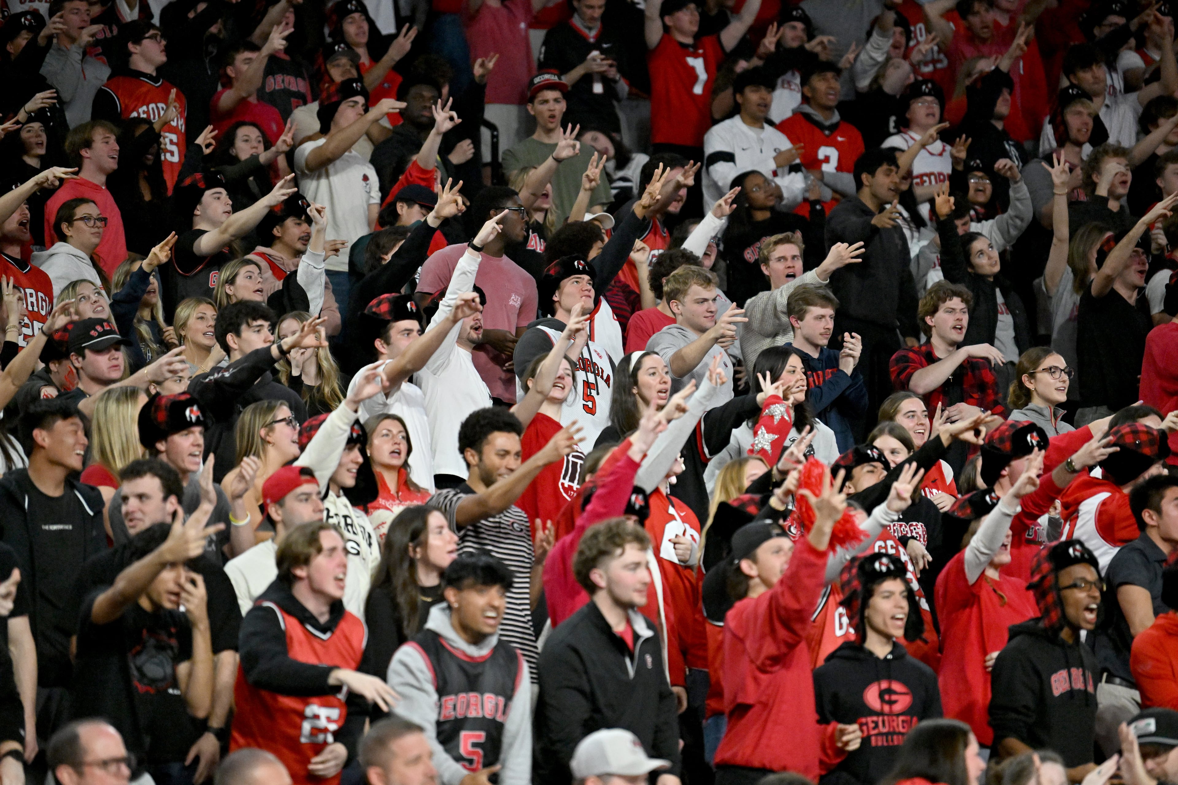 Georgia fans cheer during the second half in an NCAA college basketball game at Stegeman Coliseum, Saturday, Jan. 17, 2026, in Athens. Georgia won 90-76 over Arkansas. (Hyosub Shin/AJC)