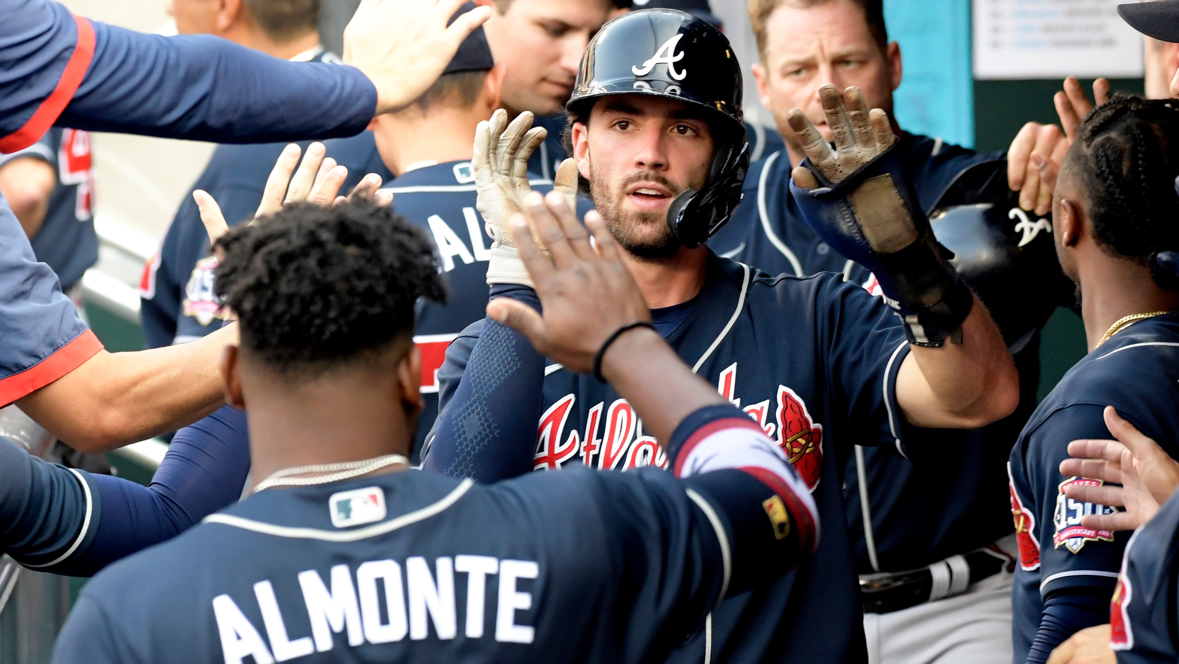 Dansby Swanson (center) celebrates with Abraham Almonte (34) after scoring during the fourth inning of Monday's doubleheader against the Mets in New York.