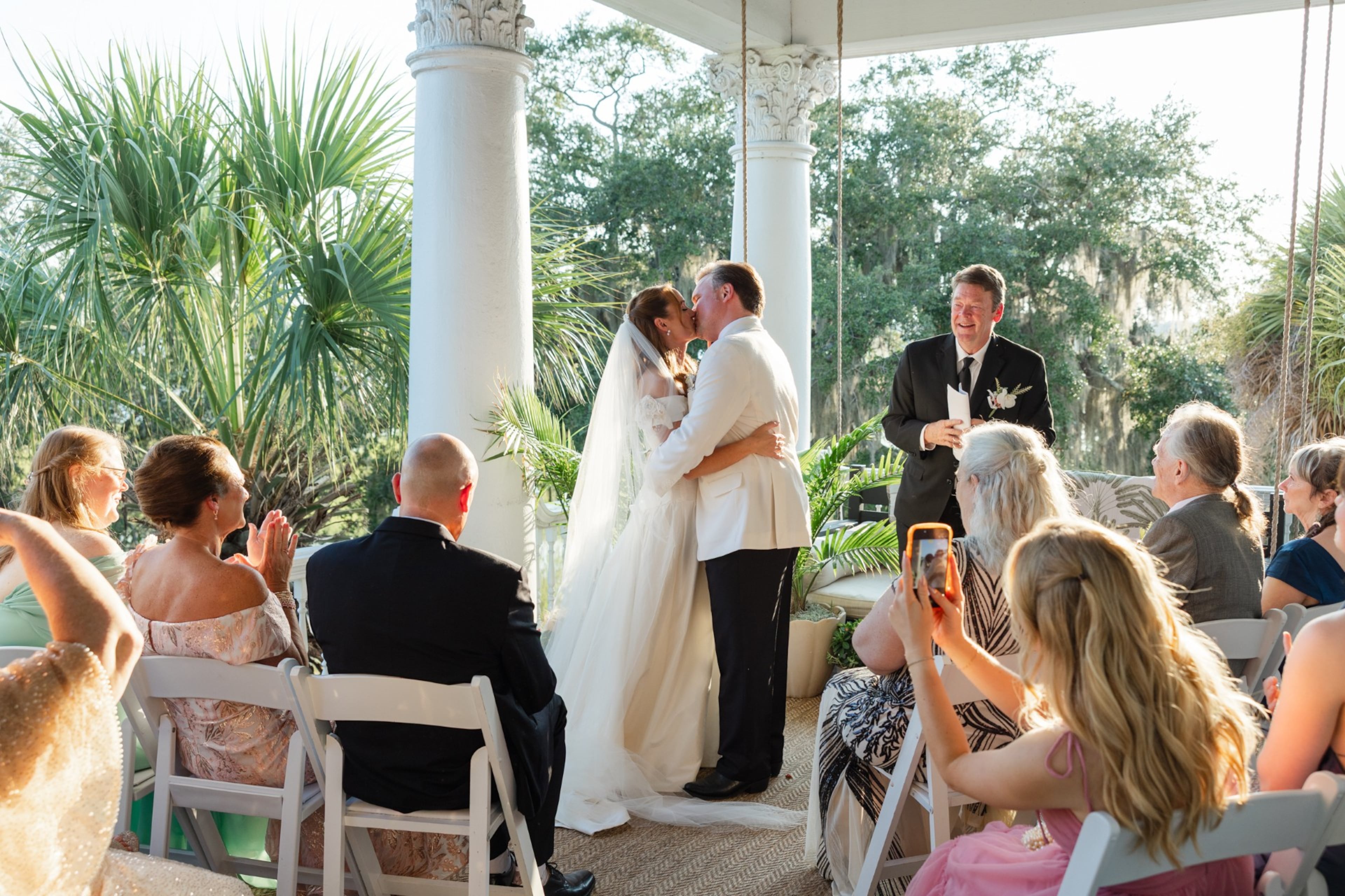 Robert Sinners (right) kisses Madeline Montgomery during their wedding ceremony in Beaufort, S.C., on Sunday. (Amber Hoecht/Amber Elizabeth Weddings)