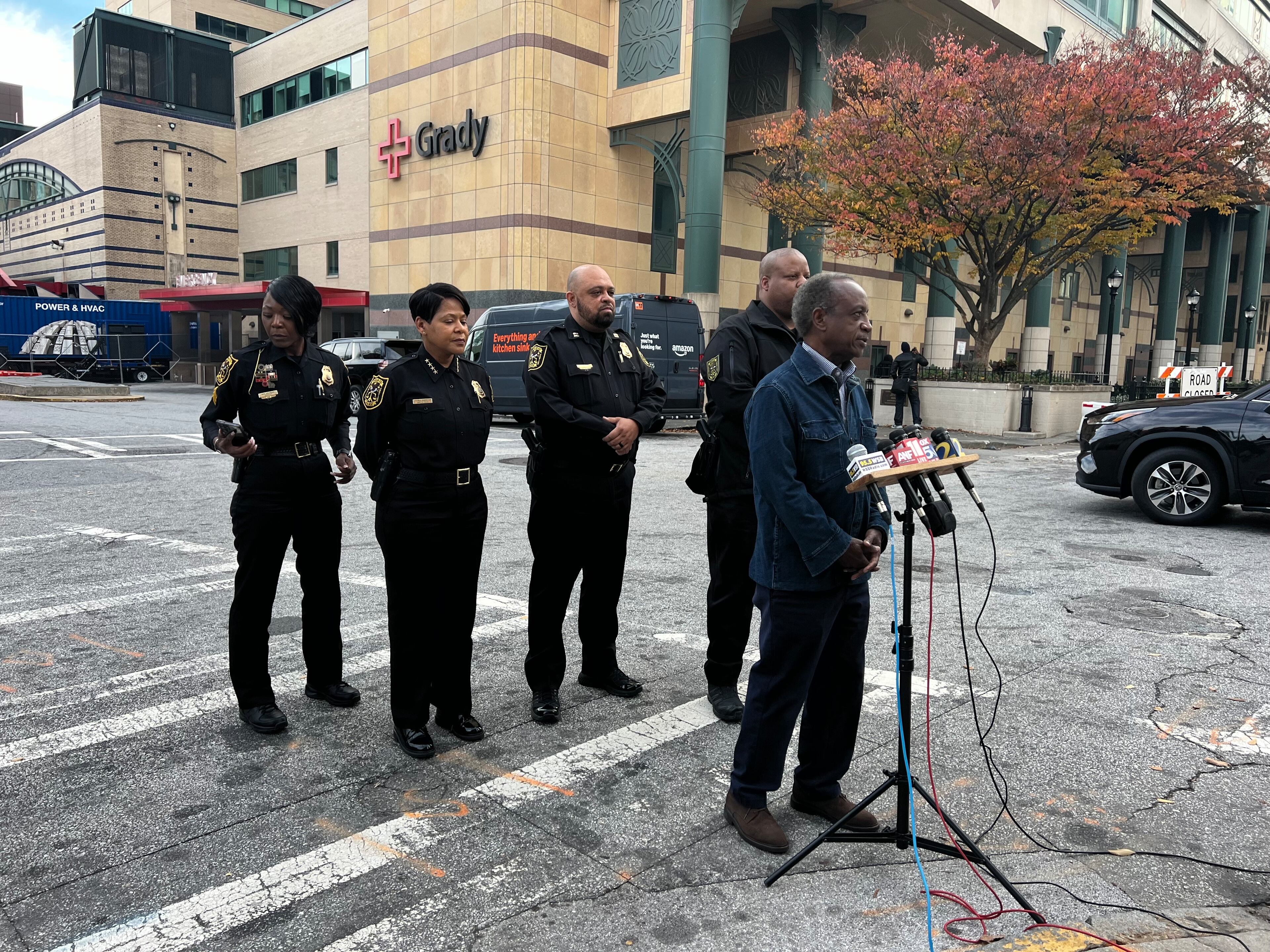 DeKalb County CEO Michael Thurmond, flanked by police Chief Mirtha Ramos, addresses the media at an impromptu news conference outside of Grady Memorial Hospital after two county police officers were injured in a shooting.