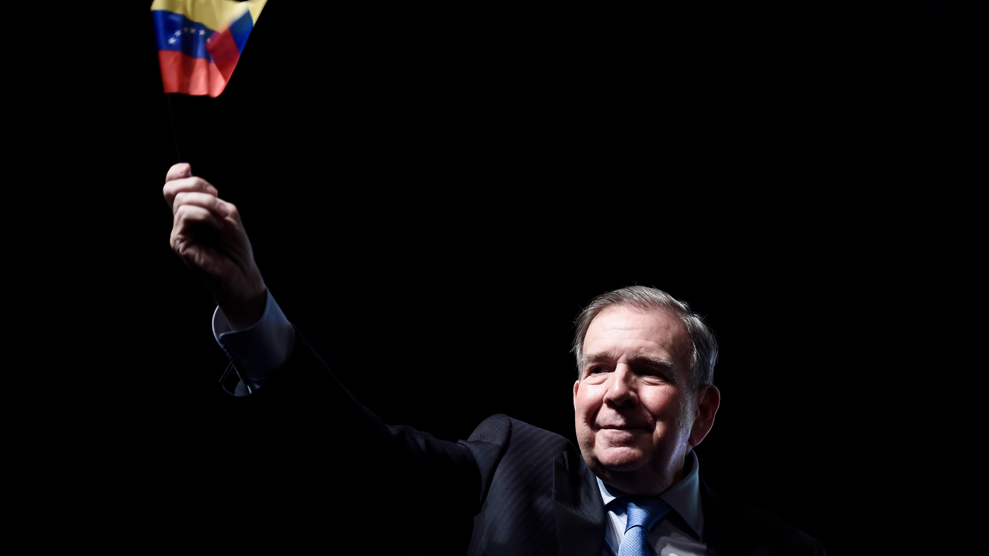 FILE - Venezuela's opposition leader Edmundo Gonzalez waves a Venezuelan flag during a meeting with supporters in Panama City, Jan. 8, 2025. (AP Photo/Agustin Herrera, File)