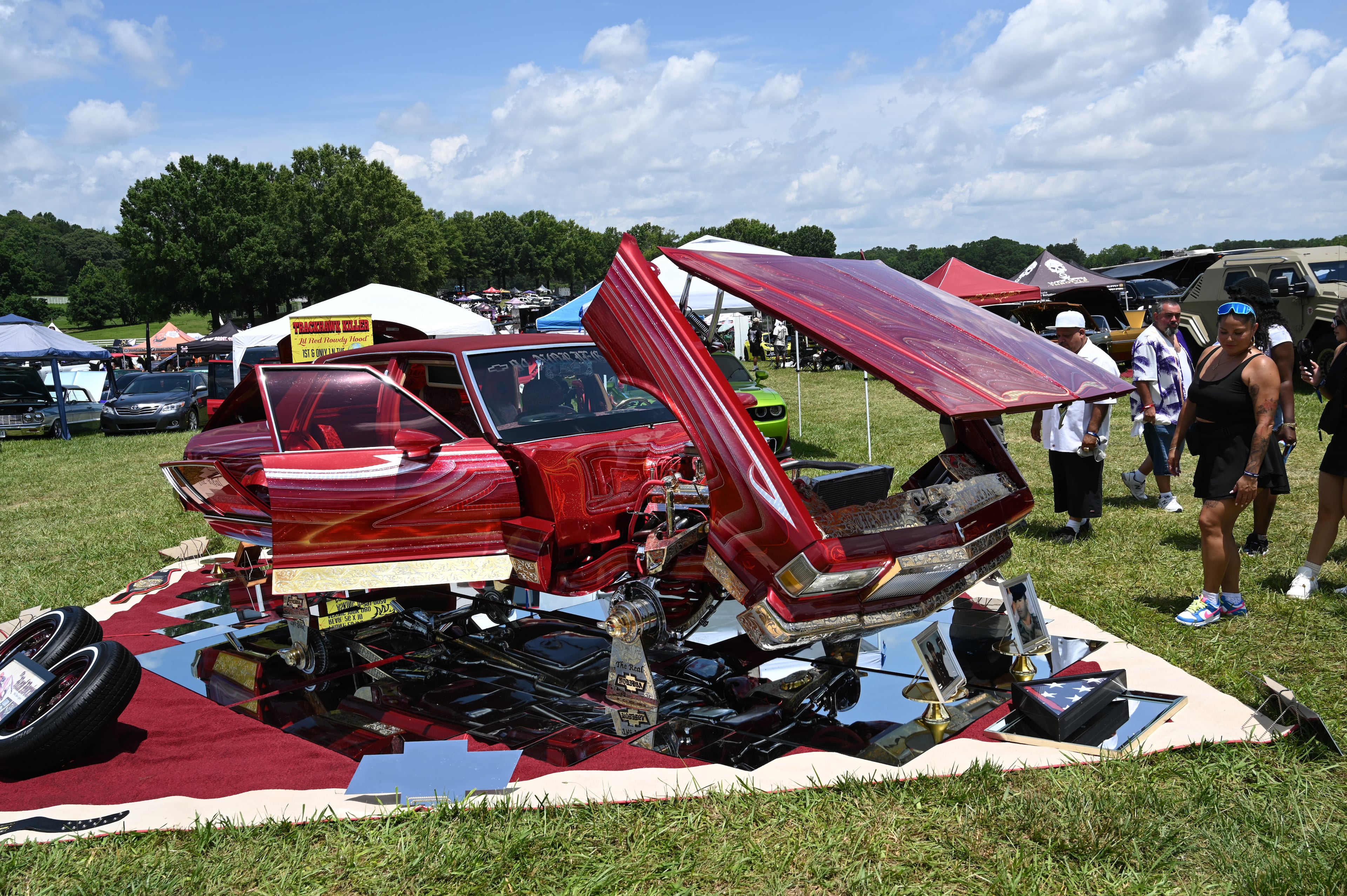 Attendees walk through some of classic/custom and luxury vehicles on Rick Ross’s property during the 4th Annual Rick Ross Car and Bike Show, Saturday, June 7, 2025, in Fayetteville. The 4th Annual Rick Ross Car and Bike Show will include a vendor market with more than 30 vendors, food trucks, fleets of classic/custom automobiles, luxury vehicles, boats, RVs and trailers on the front of the mansion. Stage performances include Plies, Ross' new signee Nino Breeze and Ross himself. (Hyosub Shin / AJC)