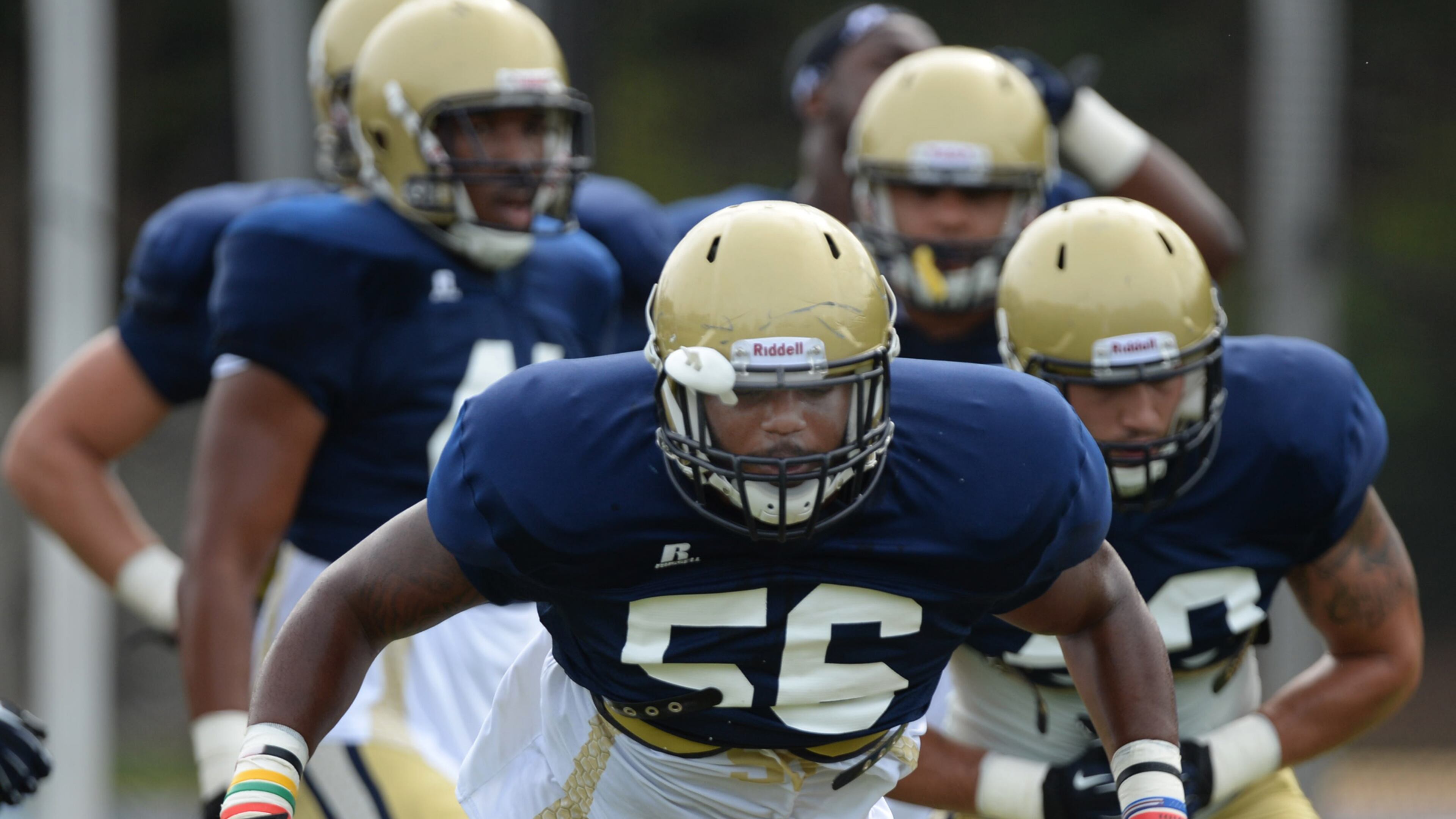 Defensive end Anthony Williams (center) is now the football coach at Locust Grove. (Johnny Crawford/AJC)