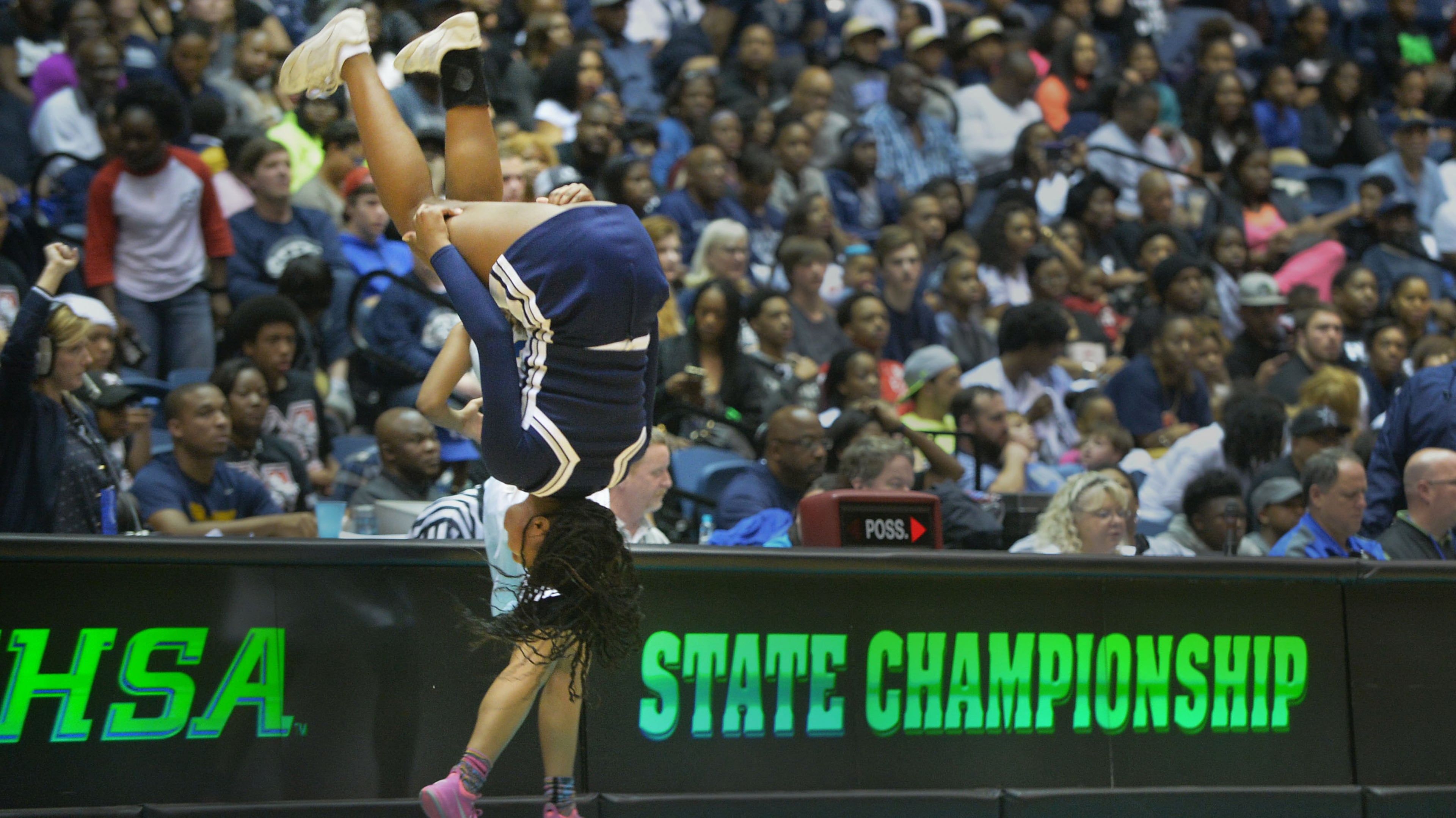 Norcross Blue Devils cheerleader does a flip during halftime of the Class AAAAAA state championship at the Macon Coliseum, Saturday, March 7, 2015.