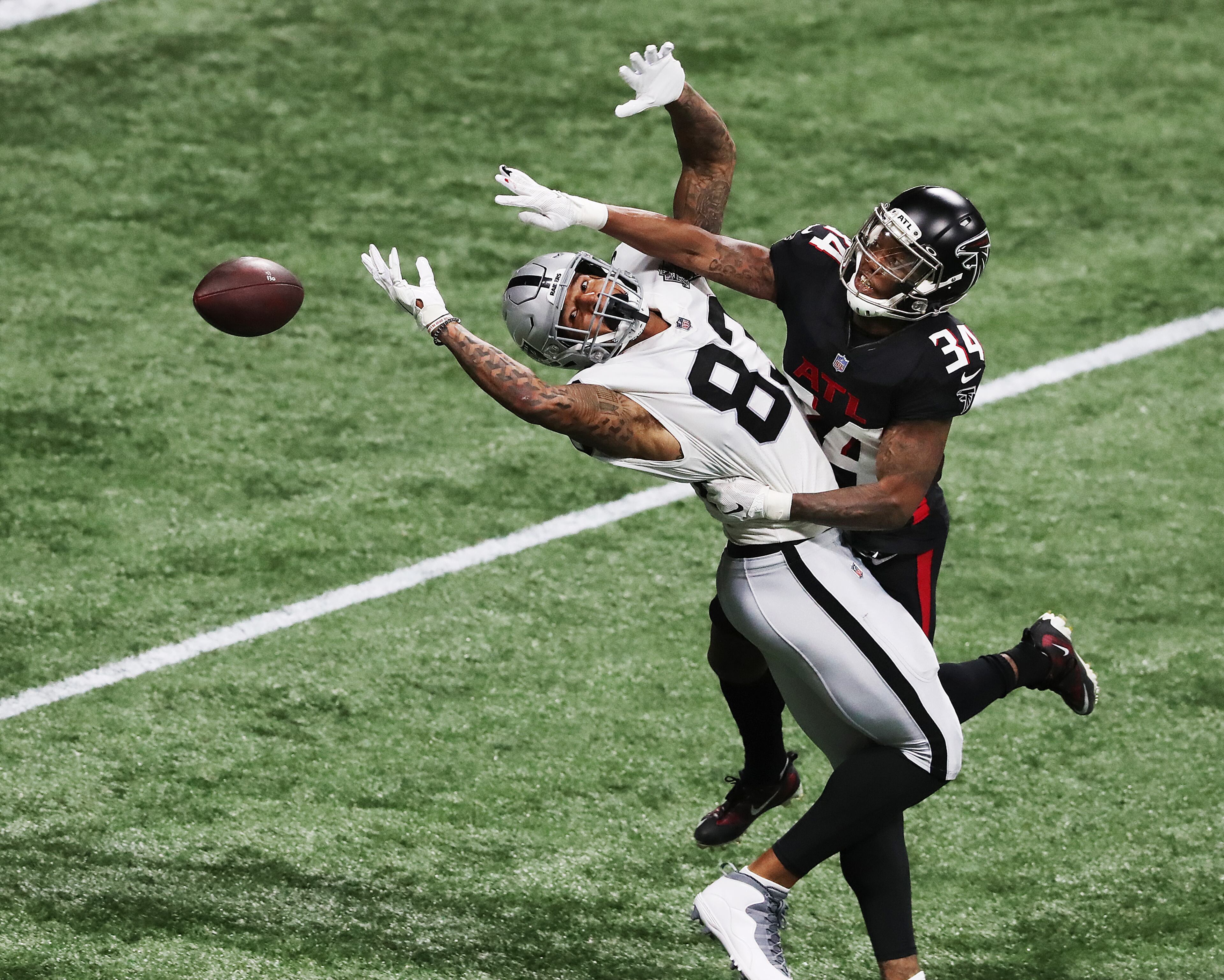 Falcons cornerback Darqueze Dennard breaks up a pass to Las Vegas Raiders tight end Darren Walker during the first quarter Sunday, Nov. 29, 2020, at Mercedes-Benz Stadium in Atlanta. (Curtis Compton / Curtis.Compton@ajc.com)