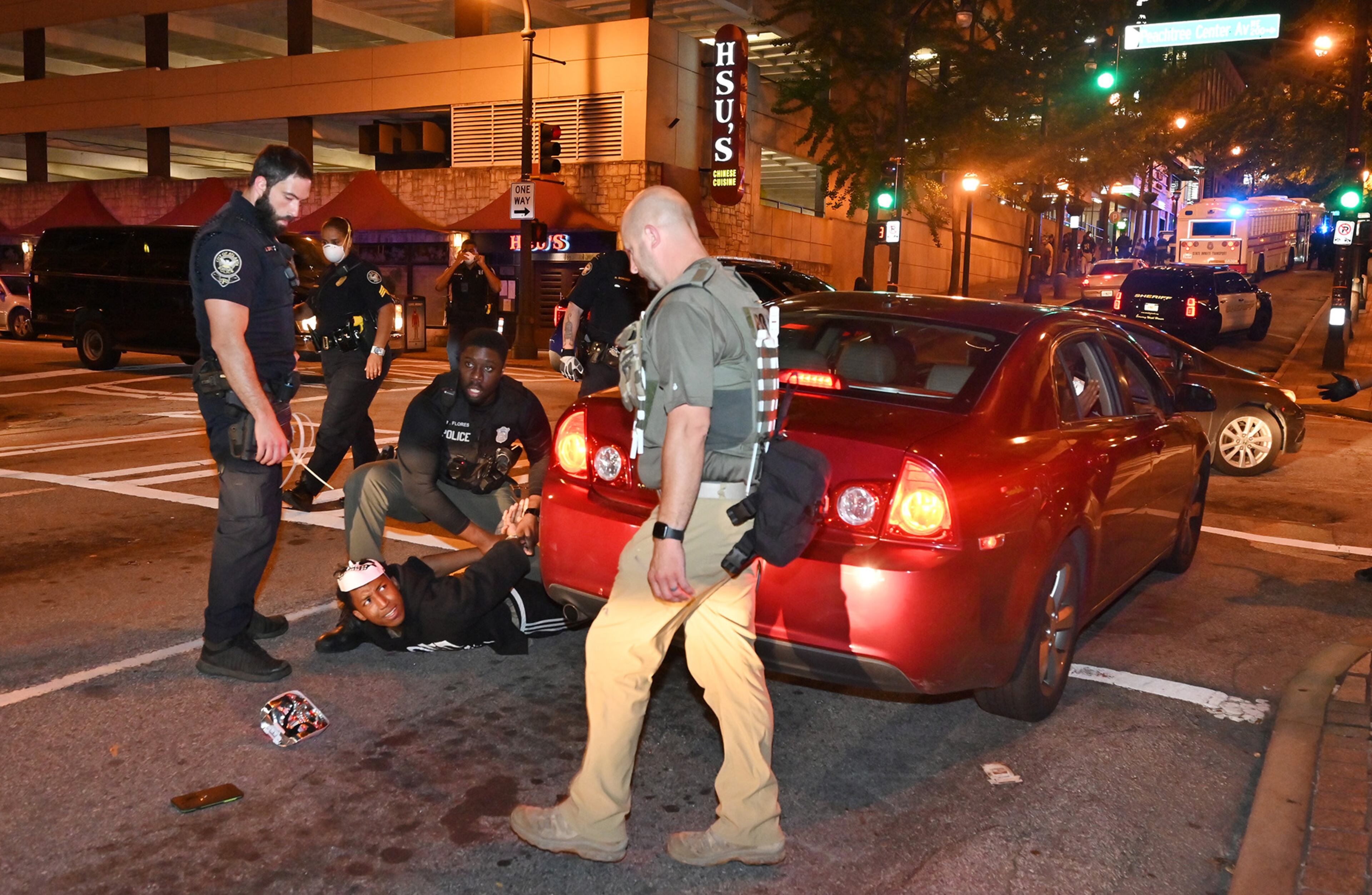 May 30, 2020 Atlanta - Police arrested protestors after curfew Saturday, some vandalizing property, as protests began for a second day in downtown Atlanta on Saturday, May 30, 2020. A second day of protests Saturday began with a crowd outside the GovernorâÃôs Mansion and grew to include demonstrations in downtown Atlanta. Mayor Keisha Lance Bottoms implemented a curfew for the city following a night of chaotic protests Friday that led to vandalism and looting in parts of downtown Atlanta and Buckhead. (Hyosub Shin / Hyosub.Shin@ajc.com)