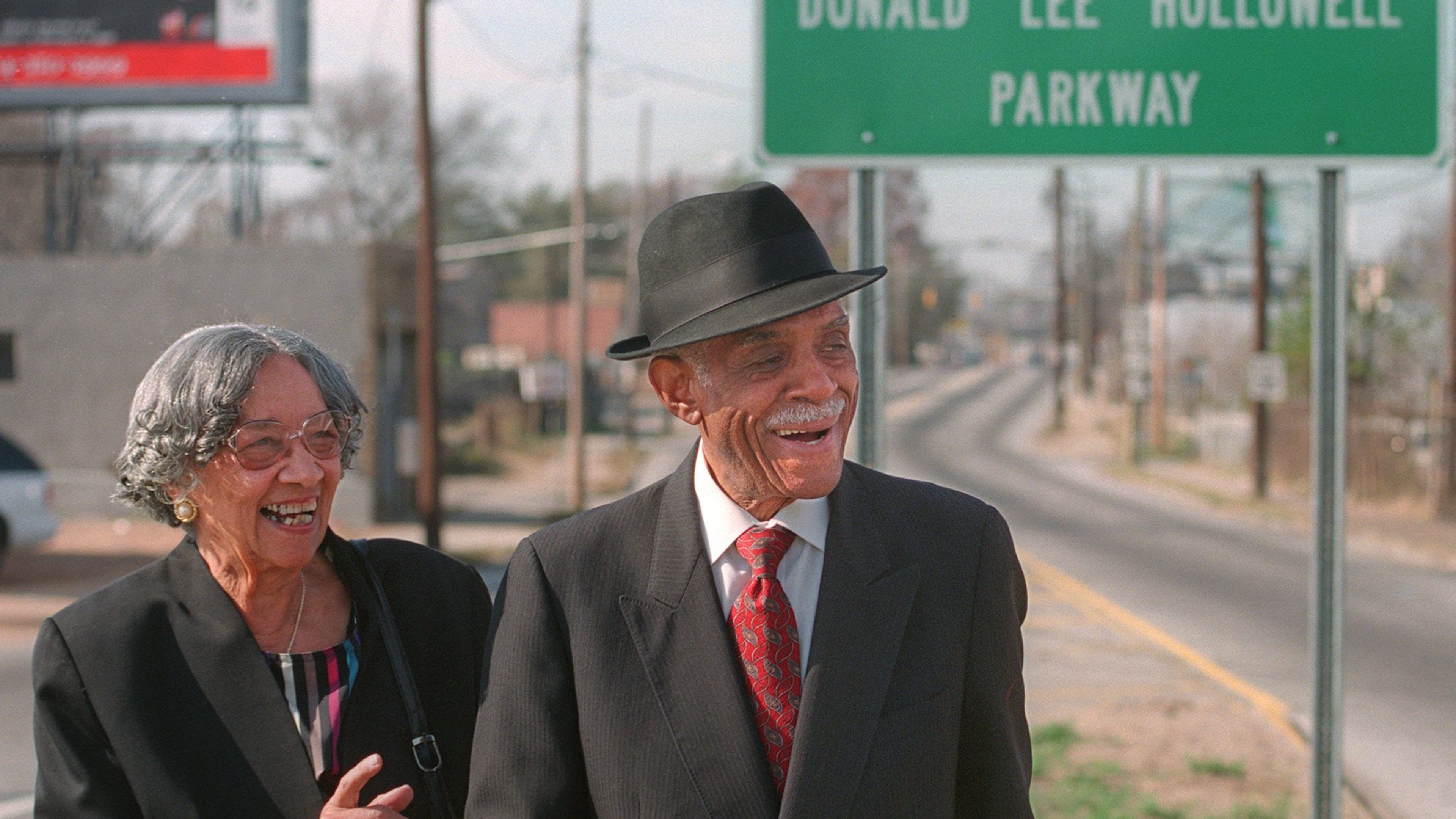 Louise Hollowell and her husband Donald Lee Hollowell standing at a road sign in Atlanta designating that Bankhead Highway had been renamed in Hollowell’s honor. Hollowell, an Atlanta attorney who died in 2004 at age 87, was a giant in the field of civil rights law. (Photo: Dec. 3, 1998/Nick Arroyo/AJC file)