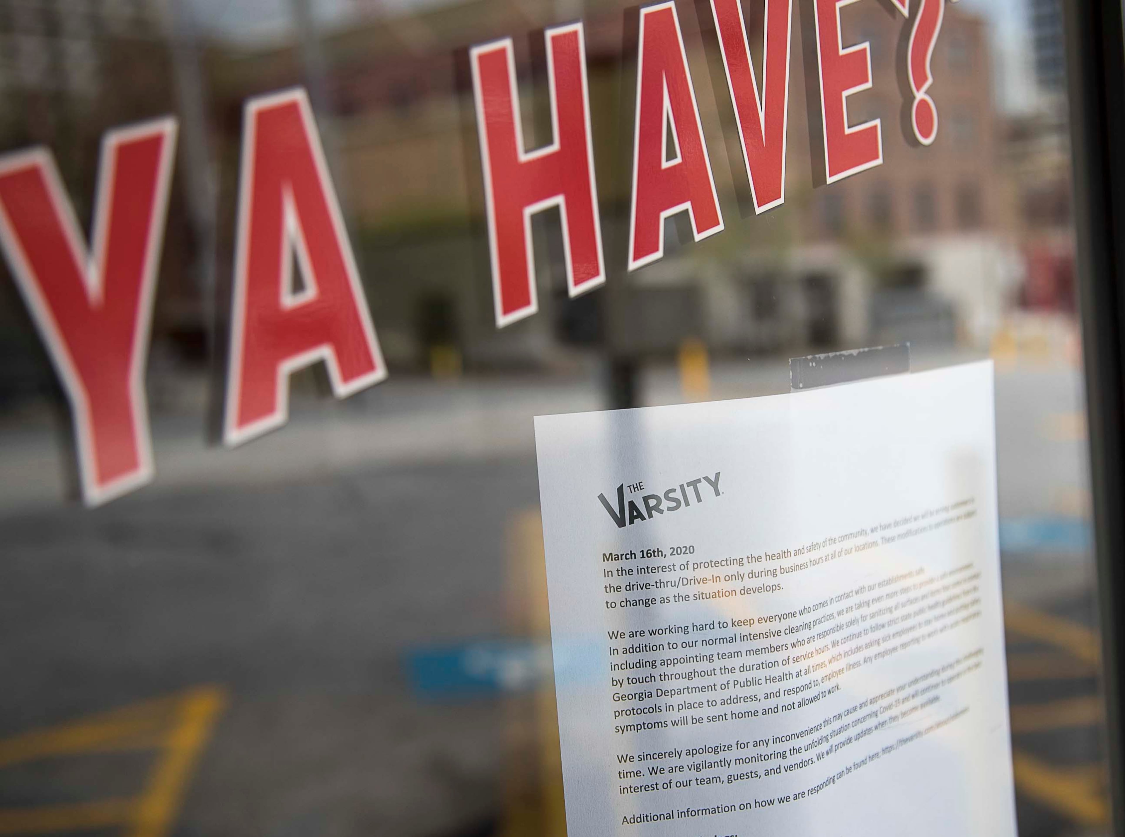 03/17/2020 -- Atlanta, Georgia -- An informative sign pertaining to recent changes in dining options is displayed on an entrance door at The Varsity, located on North Avenue, in Atlanta, Tuesday, March, 17, 2020. The Varsity, an Atlanta establishment, is one of many restaurants that have taken special measures to try and curb the spread of the coronavirus. Drive-In service will be offered at each Varsity location until further notice. As of March 16, Georgia has had more than 100 confirmed cases of the coronavirus. The coronavirus, or COVID-19, has reached the level of global pandemic in the past week, causing panic among United States citizens. (ALYSSA POINTER/ALYSSA.POINTER@AJC.COM)