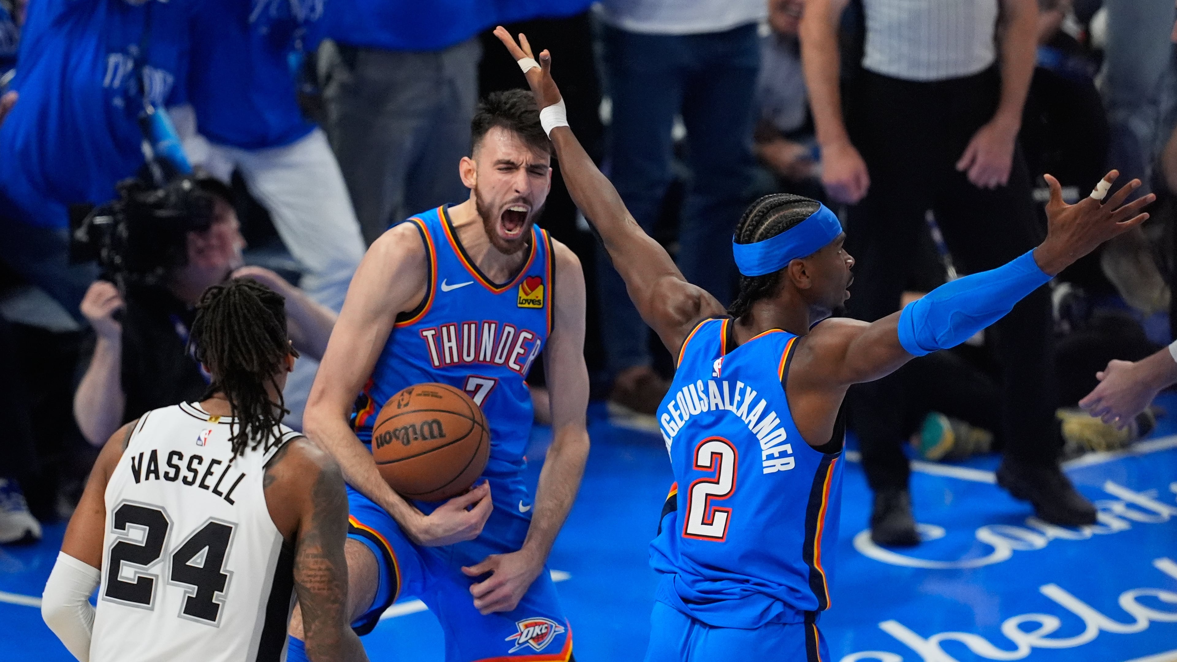 Oklahoma City Thunder center Chet Holmgren (7) celebrates with guard Shai Gilgeous-Alexander (2) after a dunk during the second half of Game 2 in the Western Conference finals NBA basketball playoffs series against the Oklahoma City Thunder Wednesday, May 20, 2026, in Oklahoma City. (AP Photo/Tony Gutierrez)
