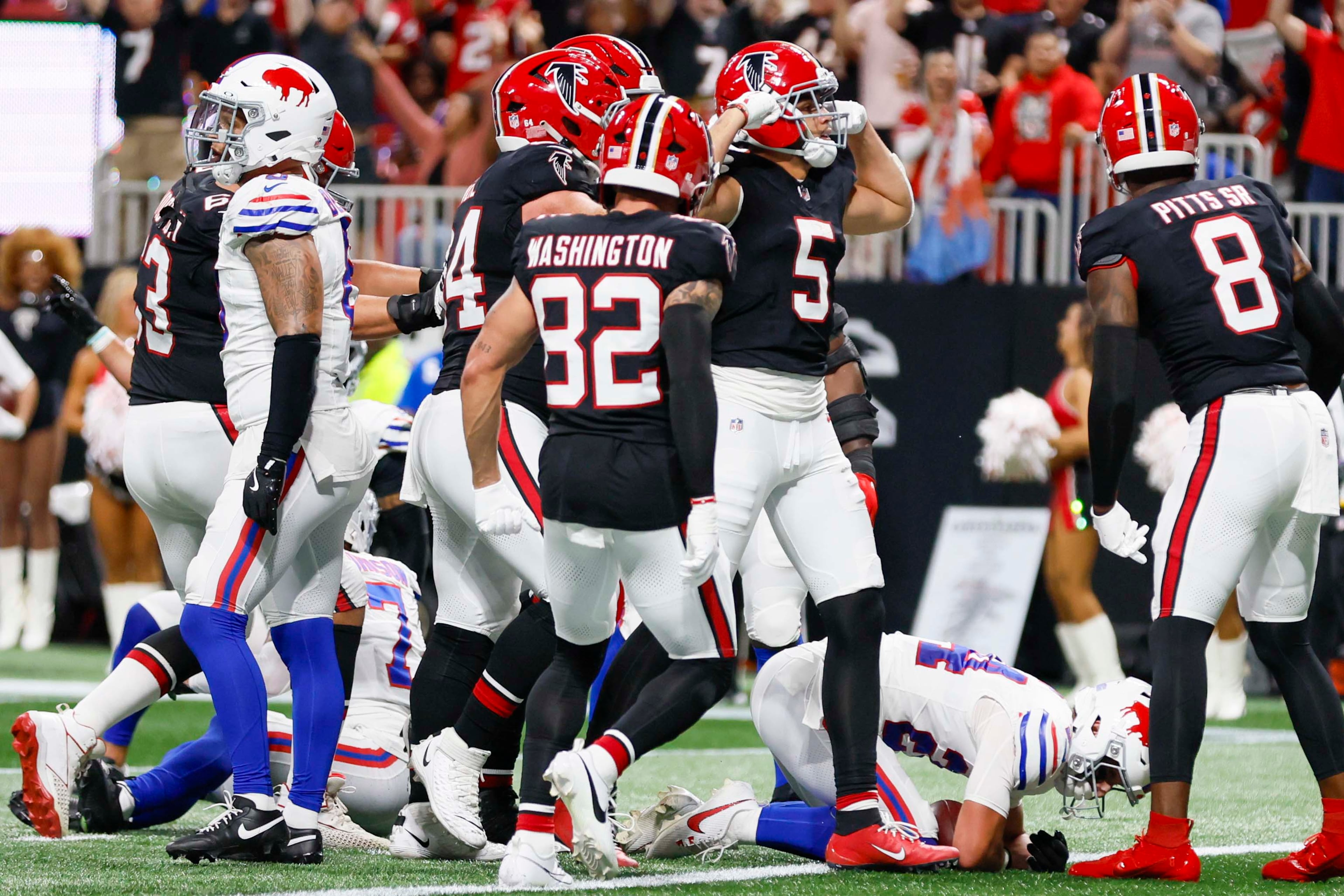 Falcons players celebrate wwith Atlanta Falcons wide receiver Drake London (second from right) after his touchdown during the first half of an NFL football game against the Buffalo Bills at Mercedes-Benz Stadium in Atlanta on Monday, October 13, 2025. (Miguel Martinez/AJC)
