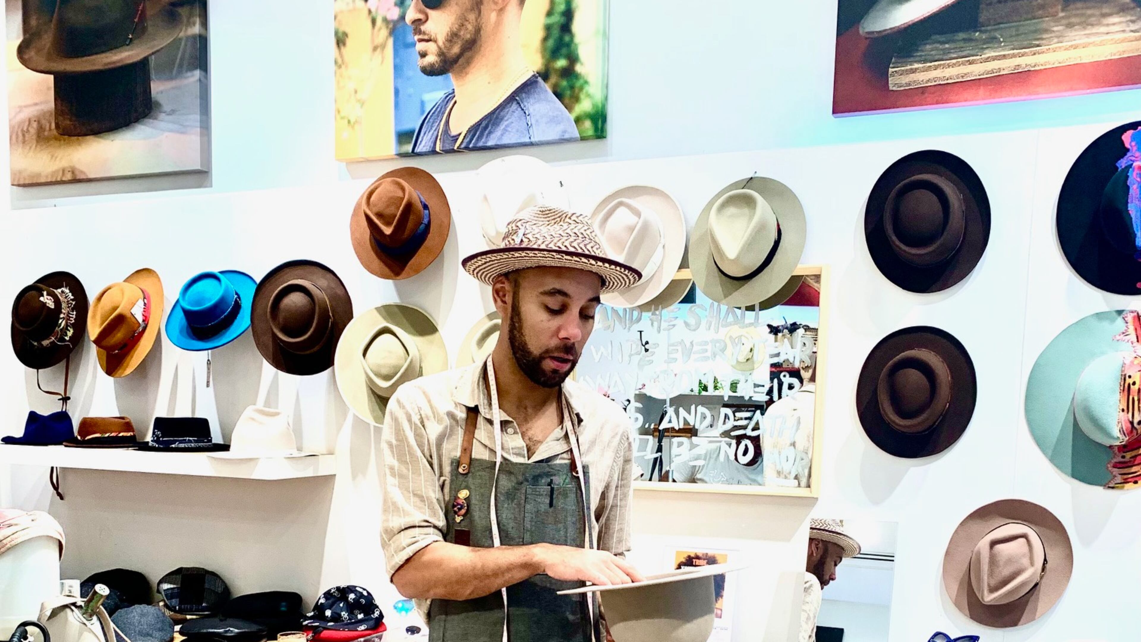 Brandon Franklin discusses hat-making techniques at his store B.M. Franklin & Co. Photo: Mary Welch for AJC