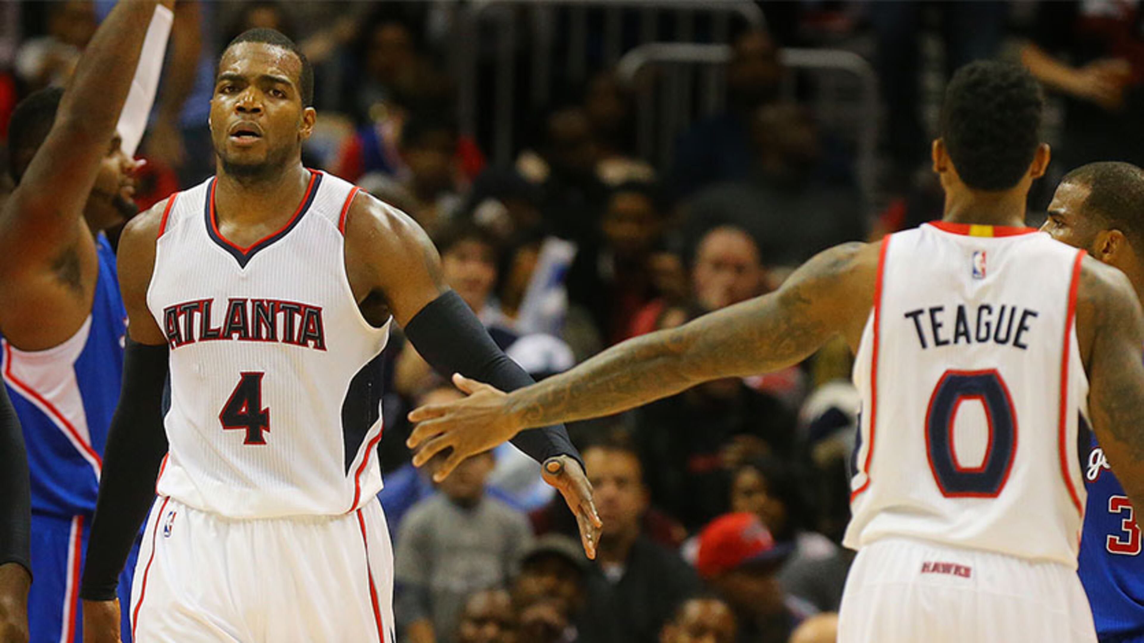 Jeff Teague gives Paul Millsap (left), a high-five after he drew a foul against the Clippers in Atlanta's 107-104 win Tuesday at Philips Arena in Atlanta.