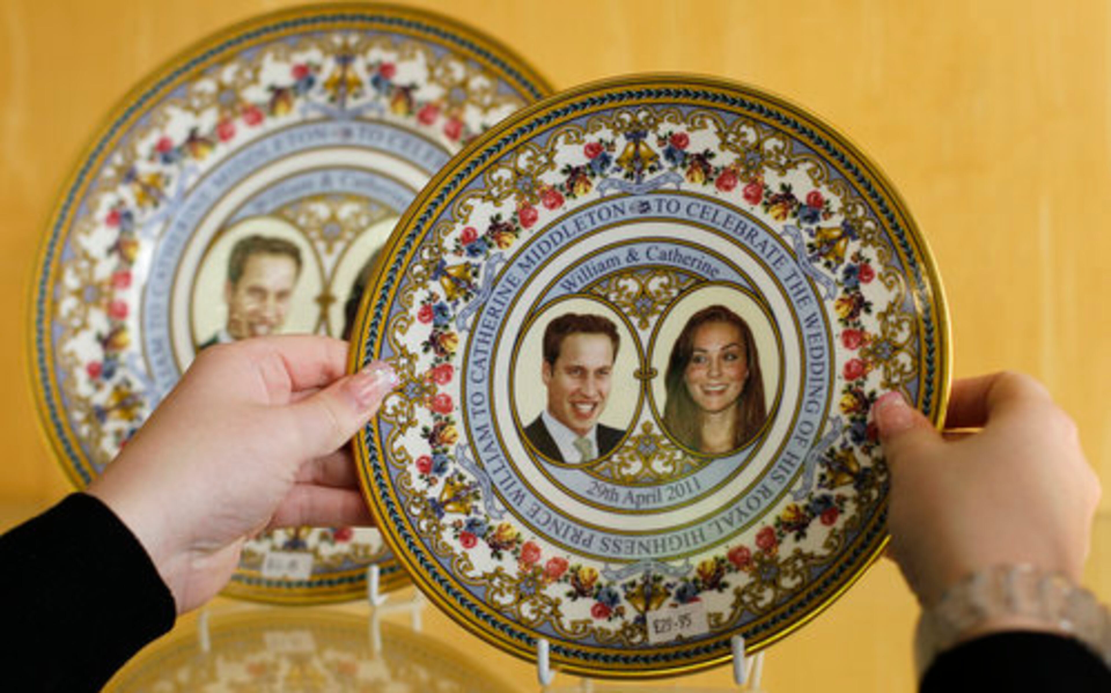 A staff member adjusts a commemorative plate for the Royal Wedding of Prince William and Kate Middleton at Church's china shop in Northampton, England. Surrounded by a mountain of boxes in a rickety old warehouse above the family shop, Joe Church is hard pressed to keep up the pace as he wraps a plate adorned with the faces of Prince William and Kate Middleton for a customer in Australia.