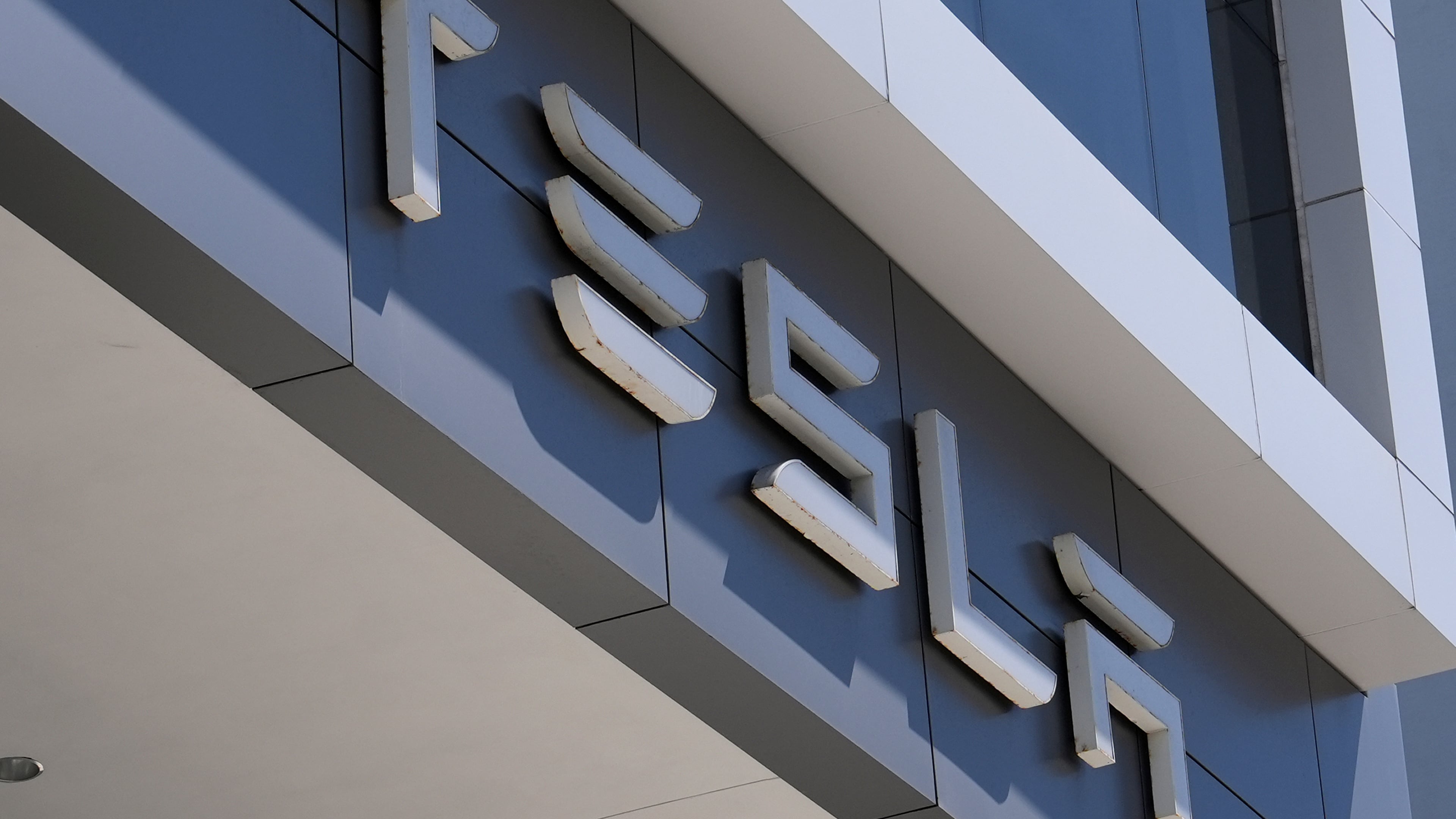 FILE - The Tesla logo is displayed at a Tesla dealership Thursday, Mar. 13, 2025, in Miami. (AP Photo/Lynne Sladky, file)