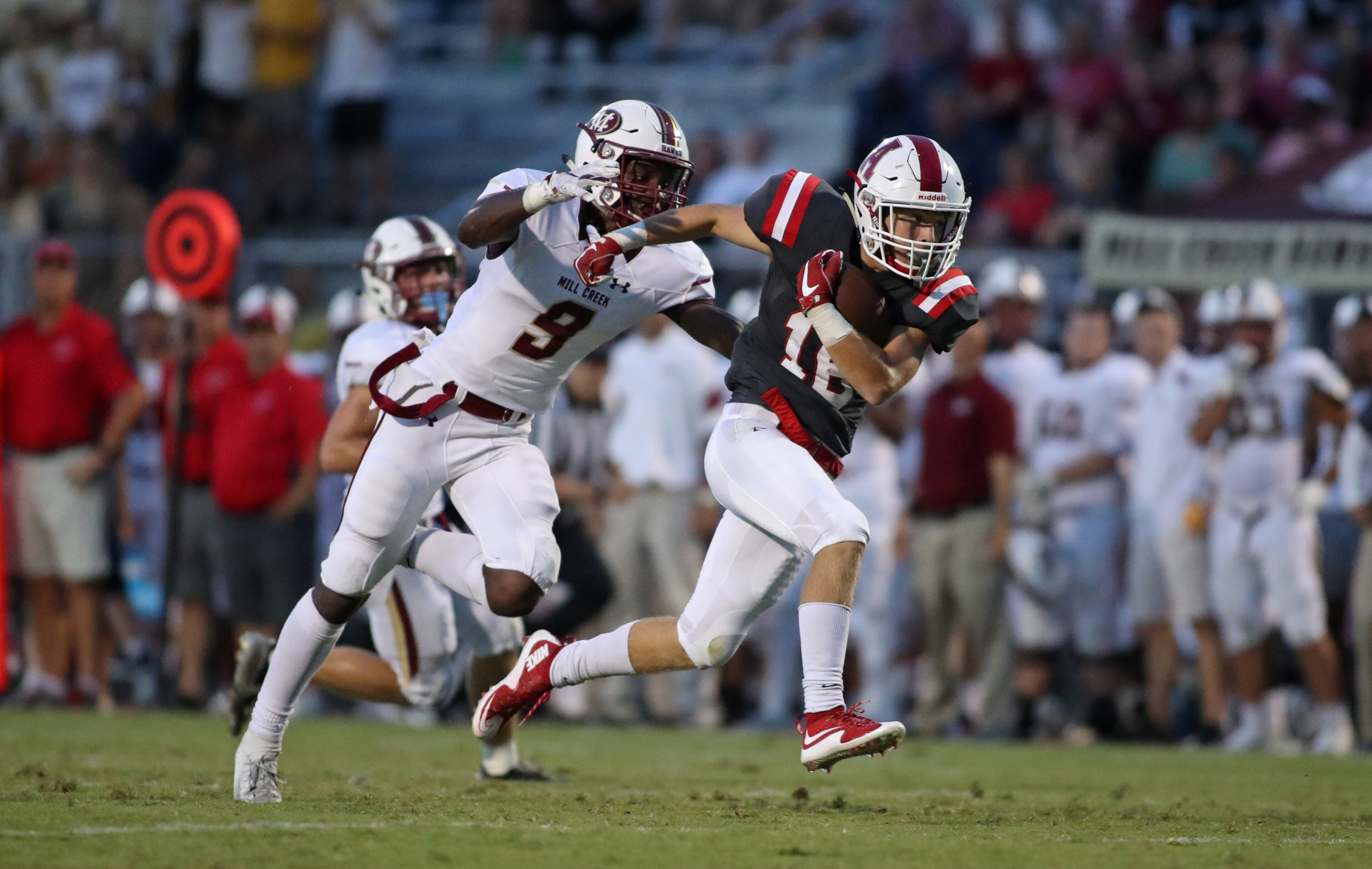 Archer wide receiver Andrew Dyer (16) runs after a catch against Mill Creek defensive back Colin Williams (9) in the first quarter at Archer High School Friday, September 7, 2018, in Lawrenceville, Ga. (JASON GETZ/SPECIAL TO THE AJC)