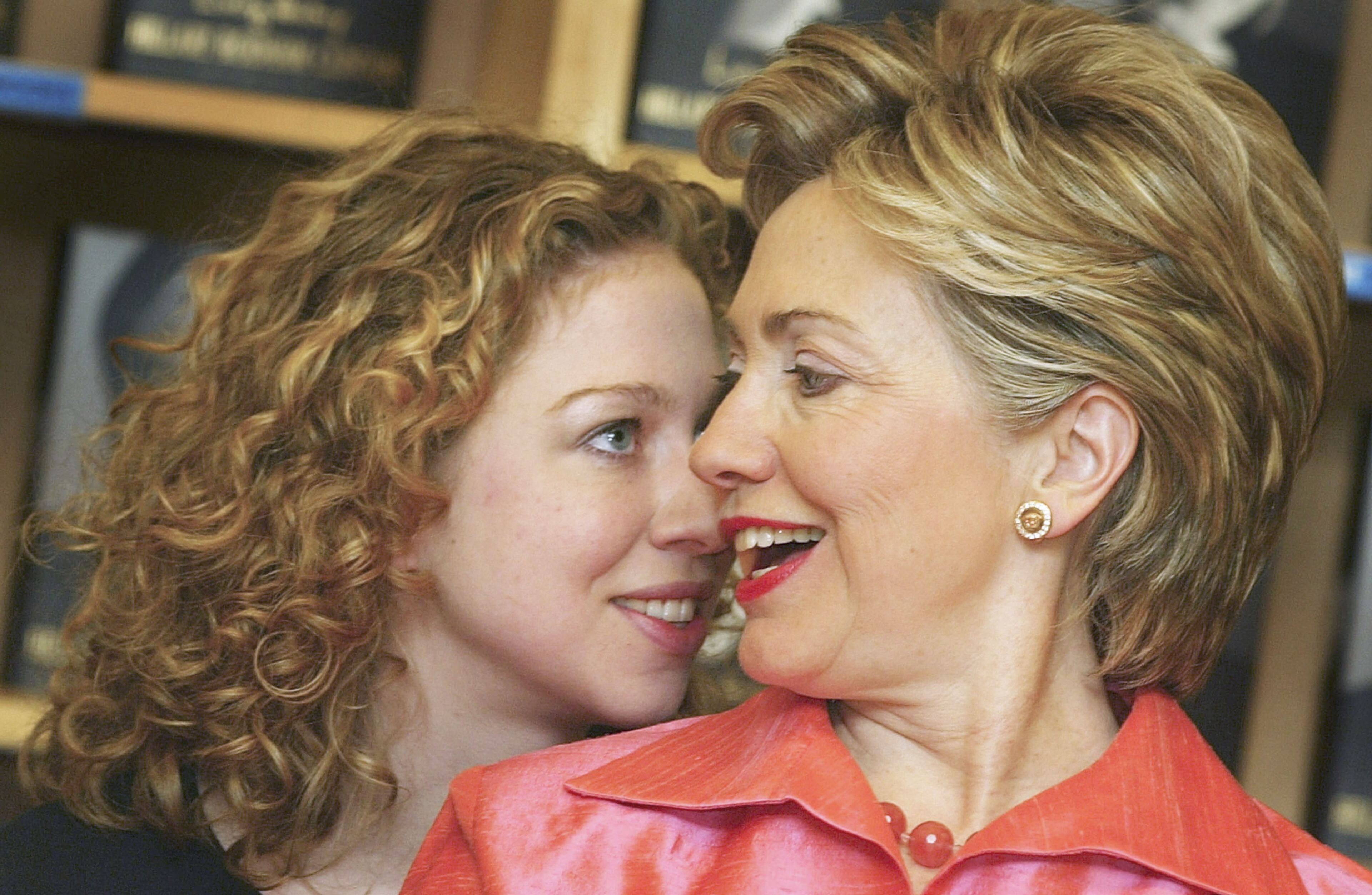 New York Senator and former U.S. First Lady, Hillary Rodham Clinton (R) shares a moment with her daughter, Chelsea, before signing copies of her autobiography, "Living History" on July 5, 2003 in Oxford, England. Clinton reveals her presidential ambitions and her thoughts on Monica Lewinsky in the book. (Photo by Scott Barbour/Getty Images)