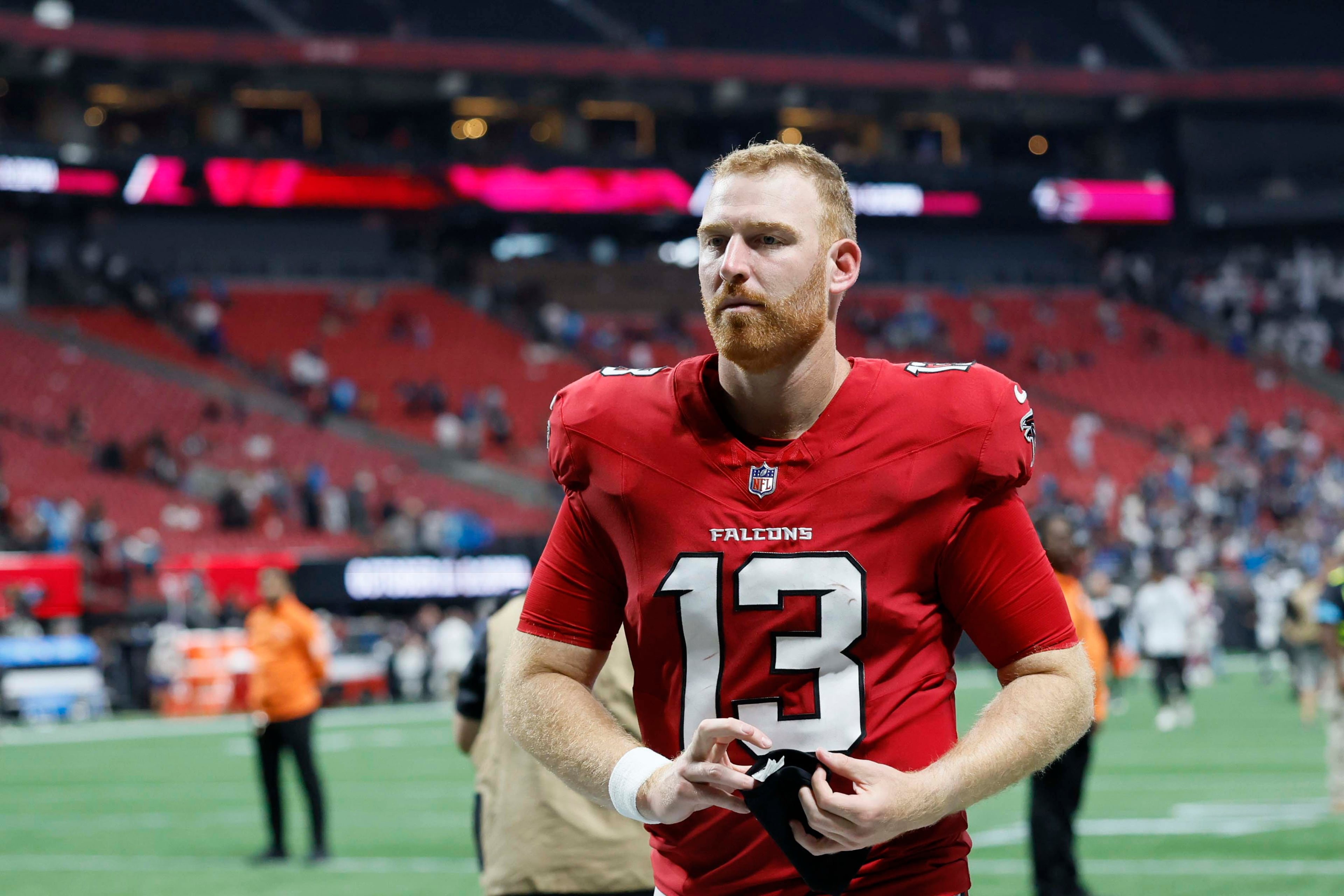 Atlanta Falcons quarterback Cooper Rush (13) leaves the field following the Falcons’ 34-3 loss to the Carolina Panthers at Mercedes-Benz Stadium in Atlanta on Sunday, Sept. 20, 2026. Rush was replaced by Jack Strand (18) in the second half. (Miguel Martinez/AJC)