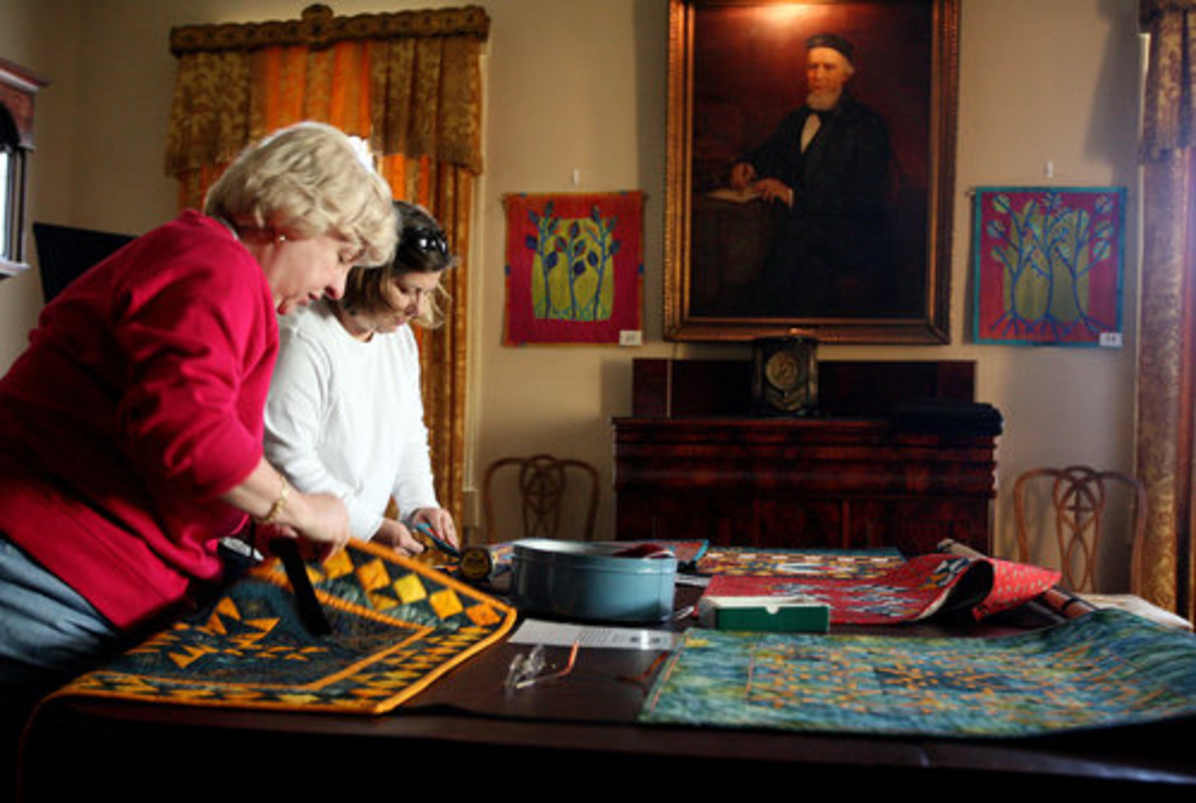 "Recycling Traditions" is the theme of this year's show at the historic home built by Major Stephens Bulloch in 1840. Volunteers Ruth Roth (left) and Diane Knott pitch in.