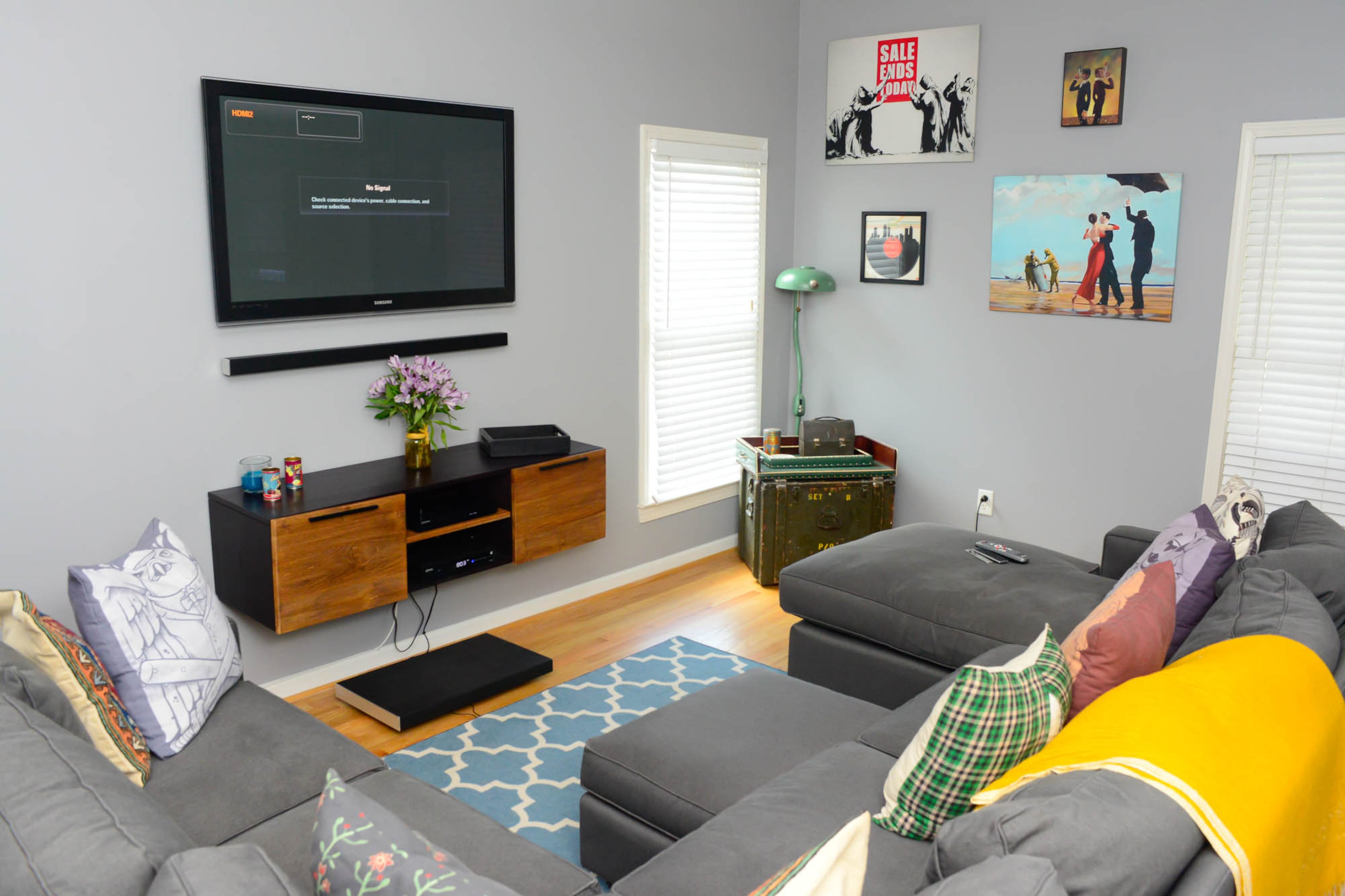 Gillese and Nash took the master bedroom and transformed it into a den to watch television. The gray sectional sofa is from Room and Board.