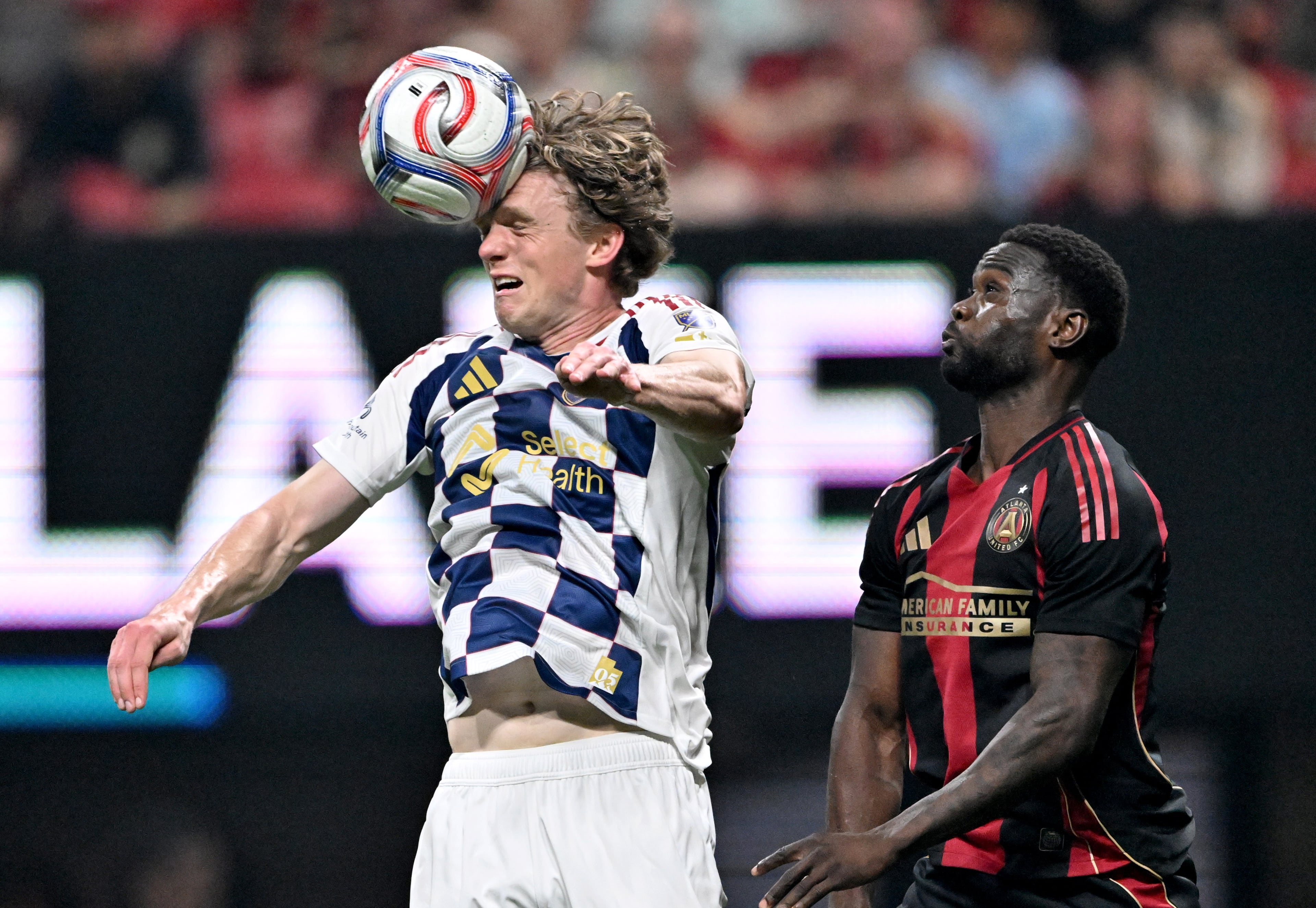 Real Salt Lake defender Philip Quinton (26) heads the ball over Atlanta United forward Emmanuel Latte Lath (9) during the first half in Atlanta United's home opener at Mercedes-Benz Stadium, Saturday, March 7, 2026, in Atlanta. Real Salt Lake won 3-2 over Atlanta United. (Hyosub Shin/AJC)