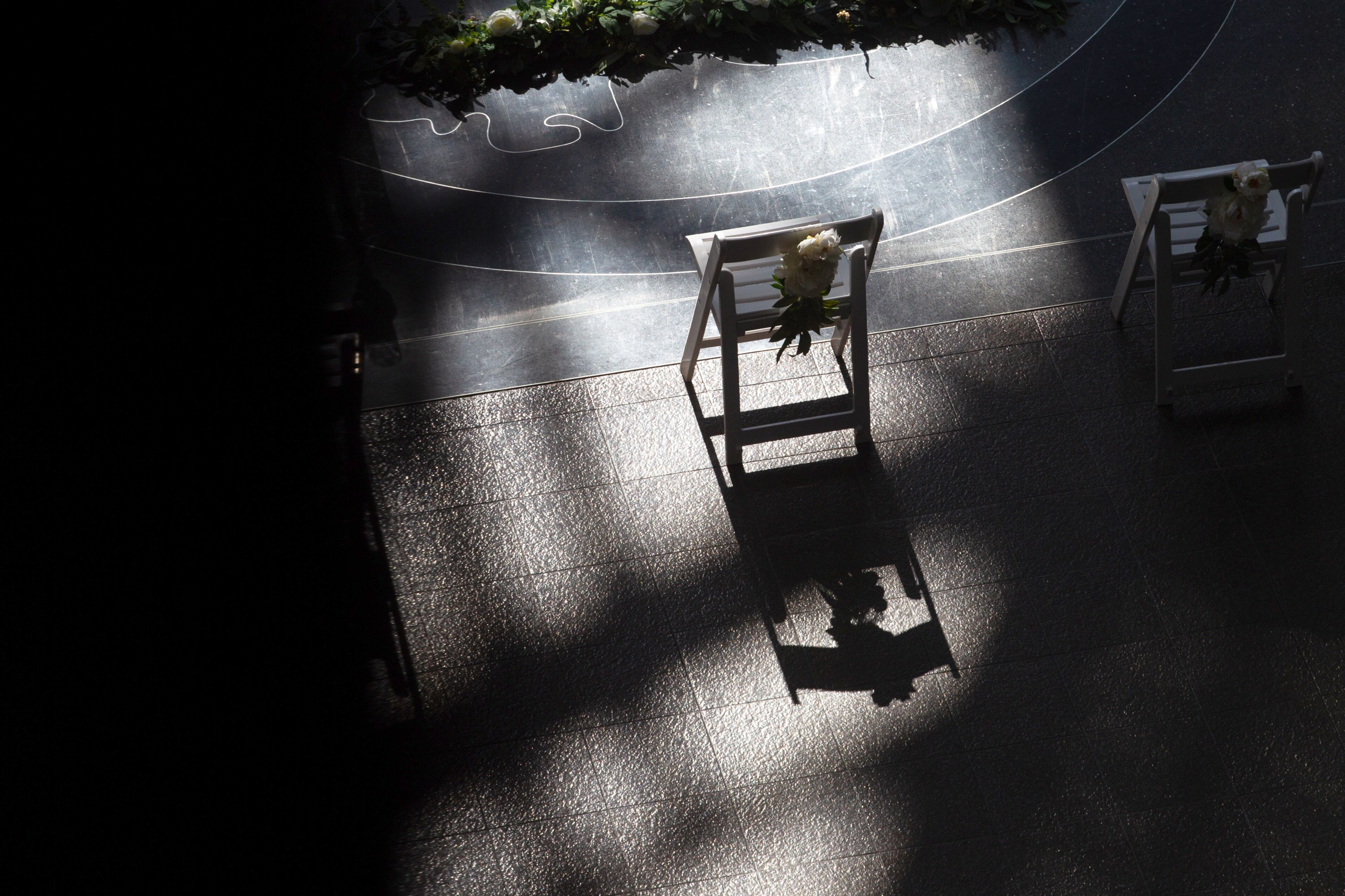 A chair sits empty before the start of a wedding ceremony in the Atrium of the Fulton County Gov. Bldg. on valentines day, February 14, 2022. STEVE SCHAEFER FOR THE ATLANTA JOURNAL-CONSTITUTION