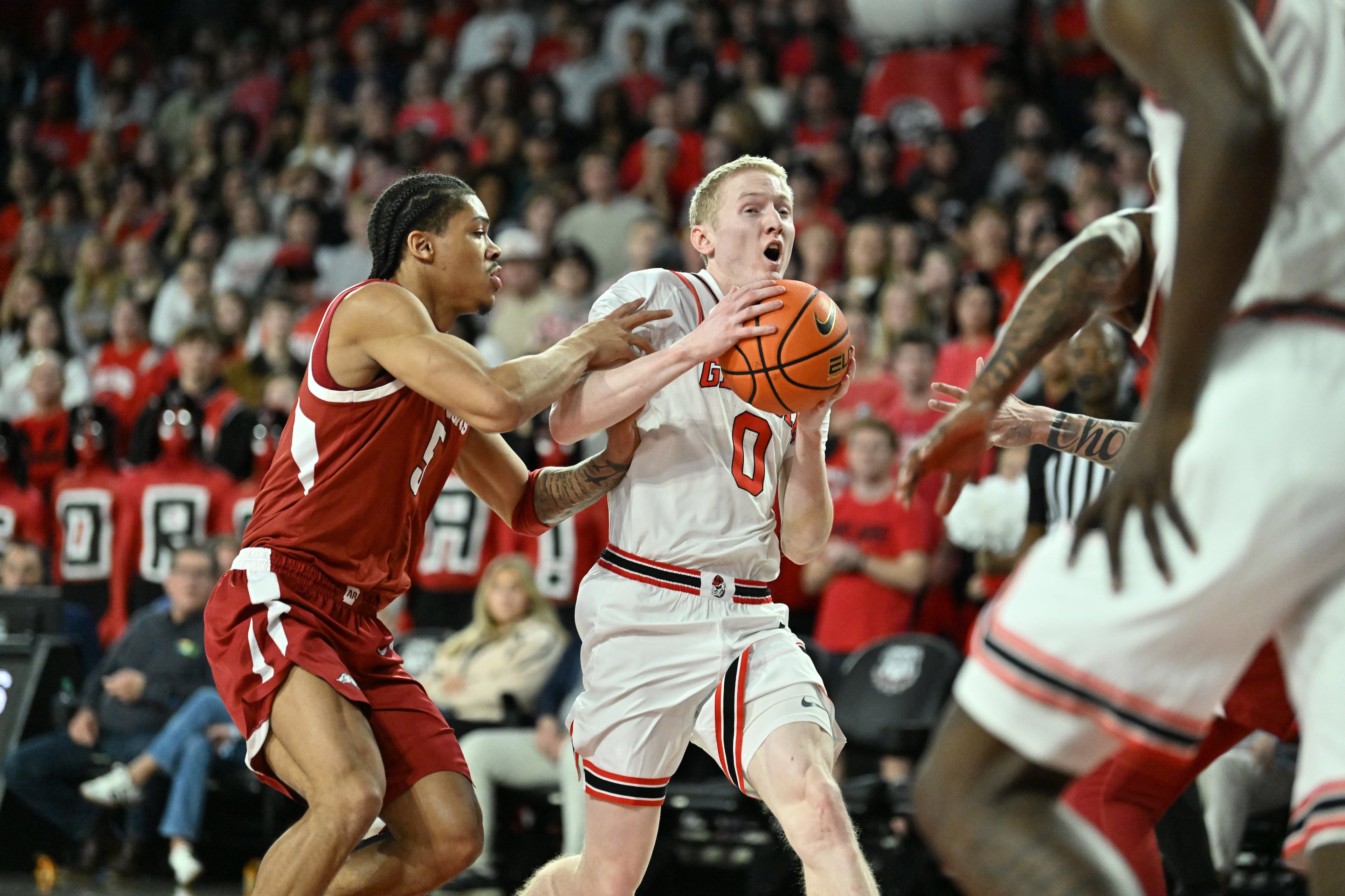 Georgia guard Blue Cain drives past Arkansas guard Darius Acuff Jr. during the first half in an NCAA college basketball game at Stegeman Coliseum, Saturday, Jan. 17, 2026, in Athens. (Hyosub Shin/AJC)