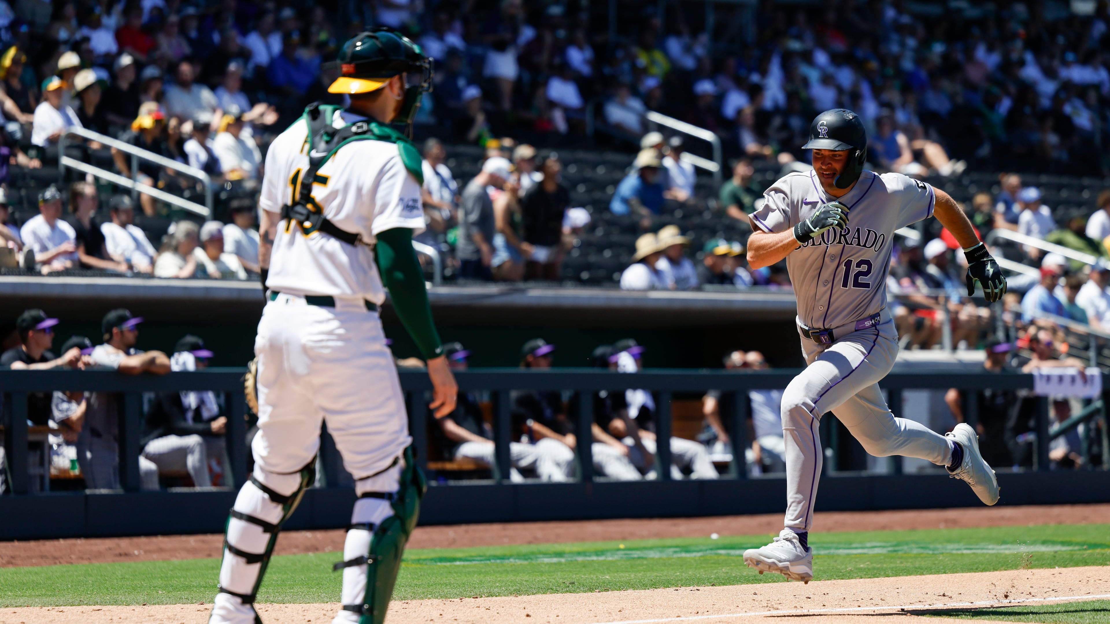 Colorado Rockies' Kyle Karros (12) runs home to score on a sacrifice fly by Braxton Fulford (37) during the fifth inning of a baseball game against the Athletics, Sunday, June 14, 2026, in Las Vegas. (AP Photo/Caroline Brehman)