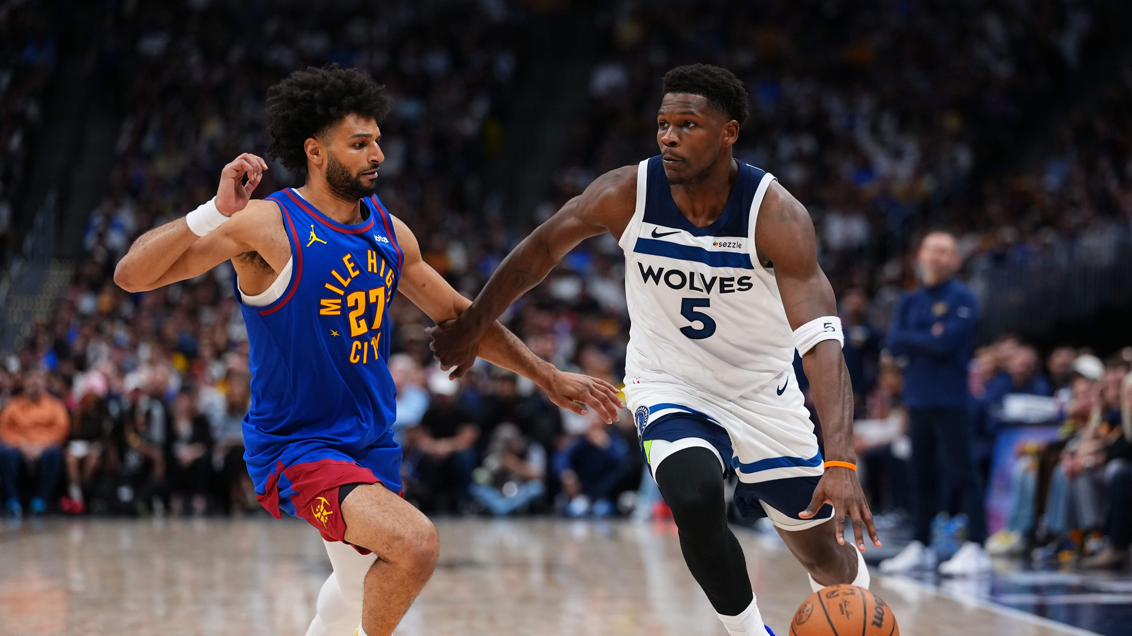 Minnesota Timberwolves guard Anthony Edwards (5) drives to the basket against Denver Nuggets guard Jamal Murray (27) during the second half in Game 2 of a first-round NBA playoffs basketball series Monday, April 20, 2026, in Denver. (AP Photo/Jack Dempsey)