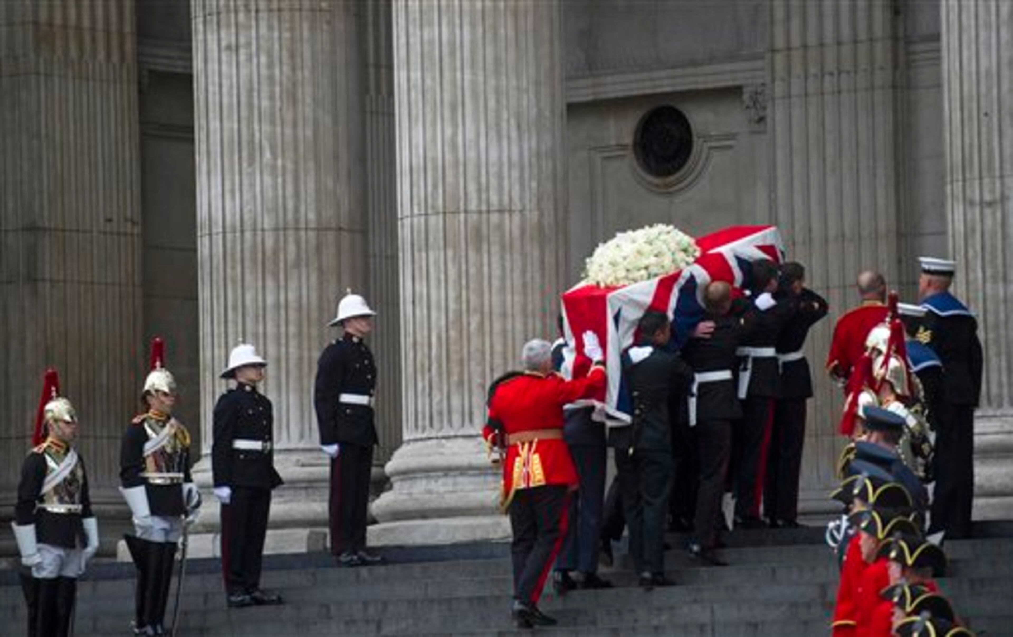 The Union flag draped coffin, holding the body of British former Prime Minister Margaret Thatcher, is carried up the stairs to St Paul's Cathedral, in London, Wednesday, April 17, 2013. It is the second time in history the Queen will be attending the funeral of a prime minister, after Winston Churchill; the ceremony will involve more than 700 Armed Forces personnel lining the route, and the Honourable Artillery Company firing Processional Minute Guns from Tower Wharf. (AP Photo/Bogdan Maran)