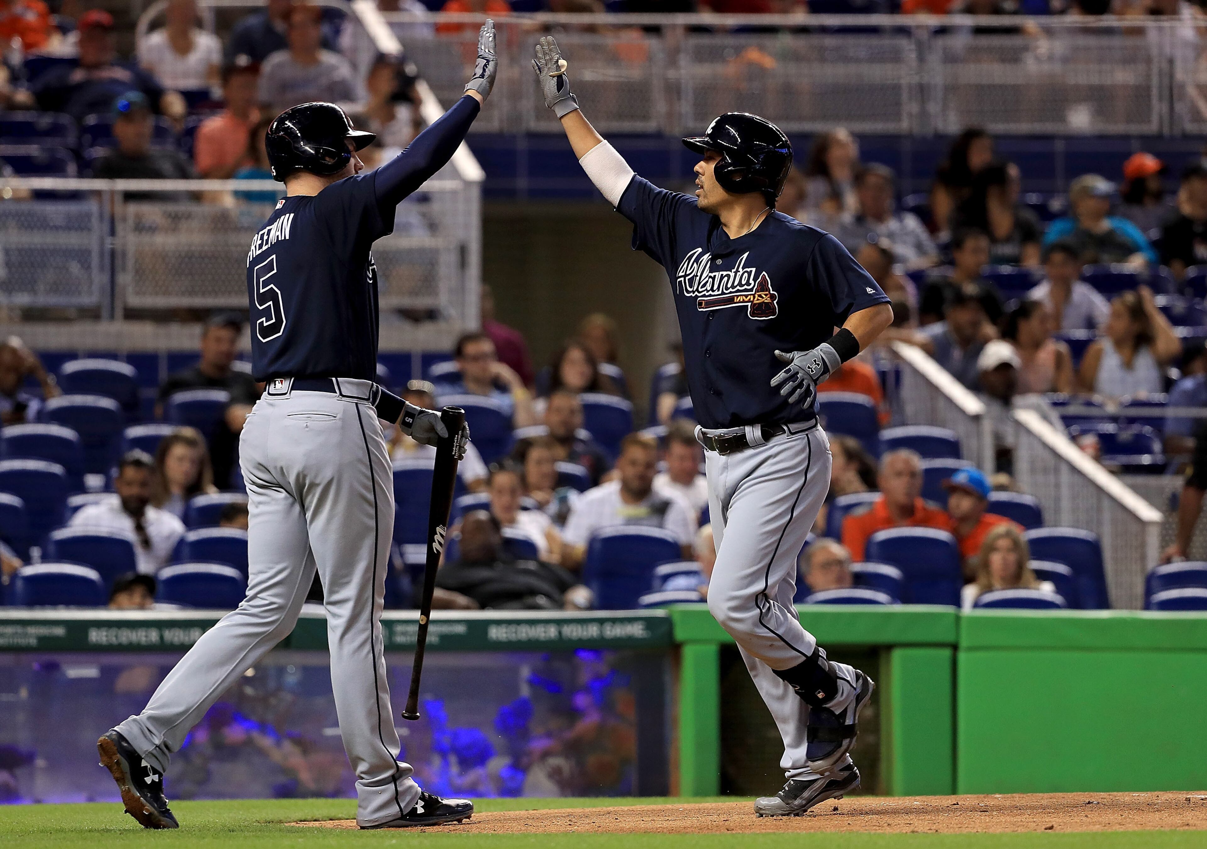MIAMI, FL - OCTOBER 01: Kurt Suzuki #24 of the Atlanta Braves is congratulated after hitting a home run in the during a game against the Miami Marlins at Marlins Park on October 1, 2017 in Miami, Florida. (Photo by Mike Ehrmann/Getty Images)
