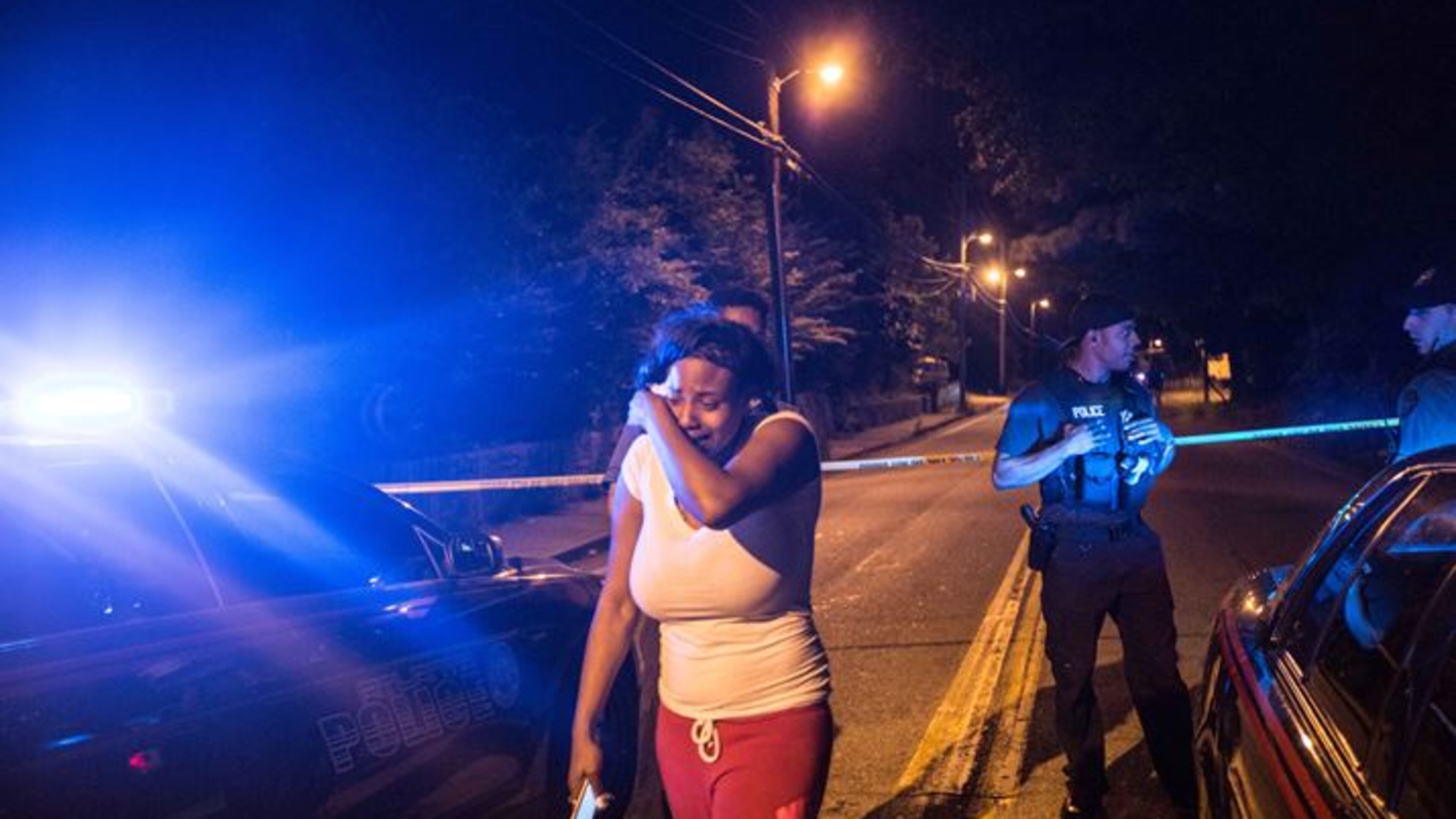 An unidentified woman cries at the scene of a fatal shooting on Hollywood Road in northwest Atlanta on Thursday night, May 14, 2015. BRANDEN CAMP / SPECIAL