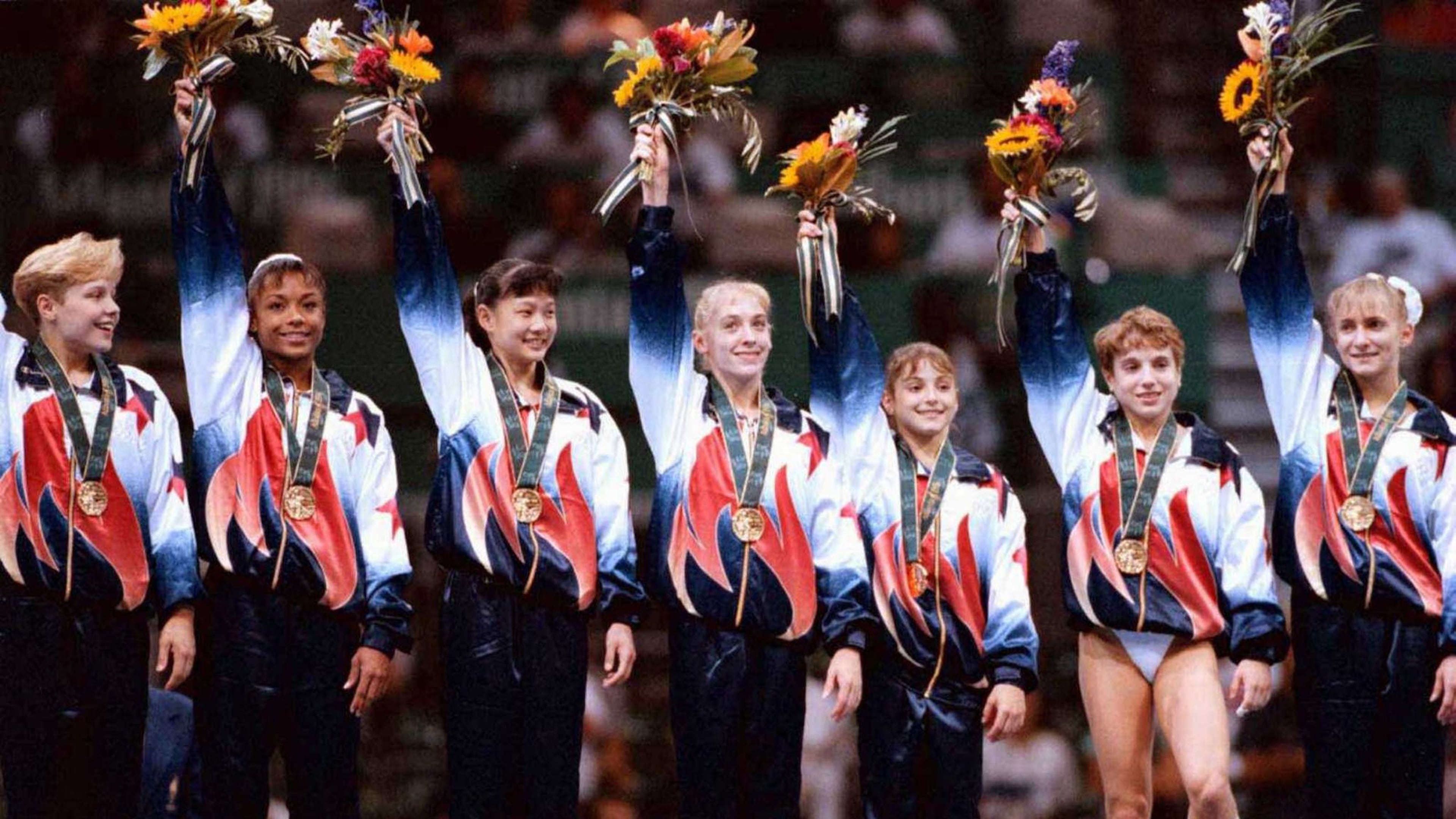 The U.S. women’s gymnastics team members (including Shannon Miller, right) accept their gold medal in the team competition in 1996 to the cheers of the home country crowd in the Georgia Dome. AJC FILE PHOTO