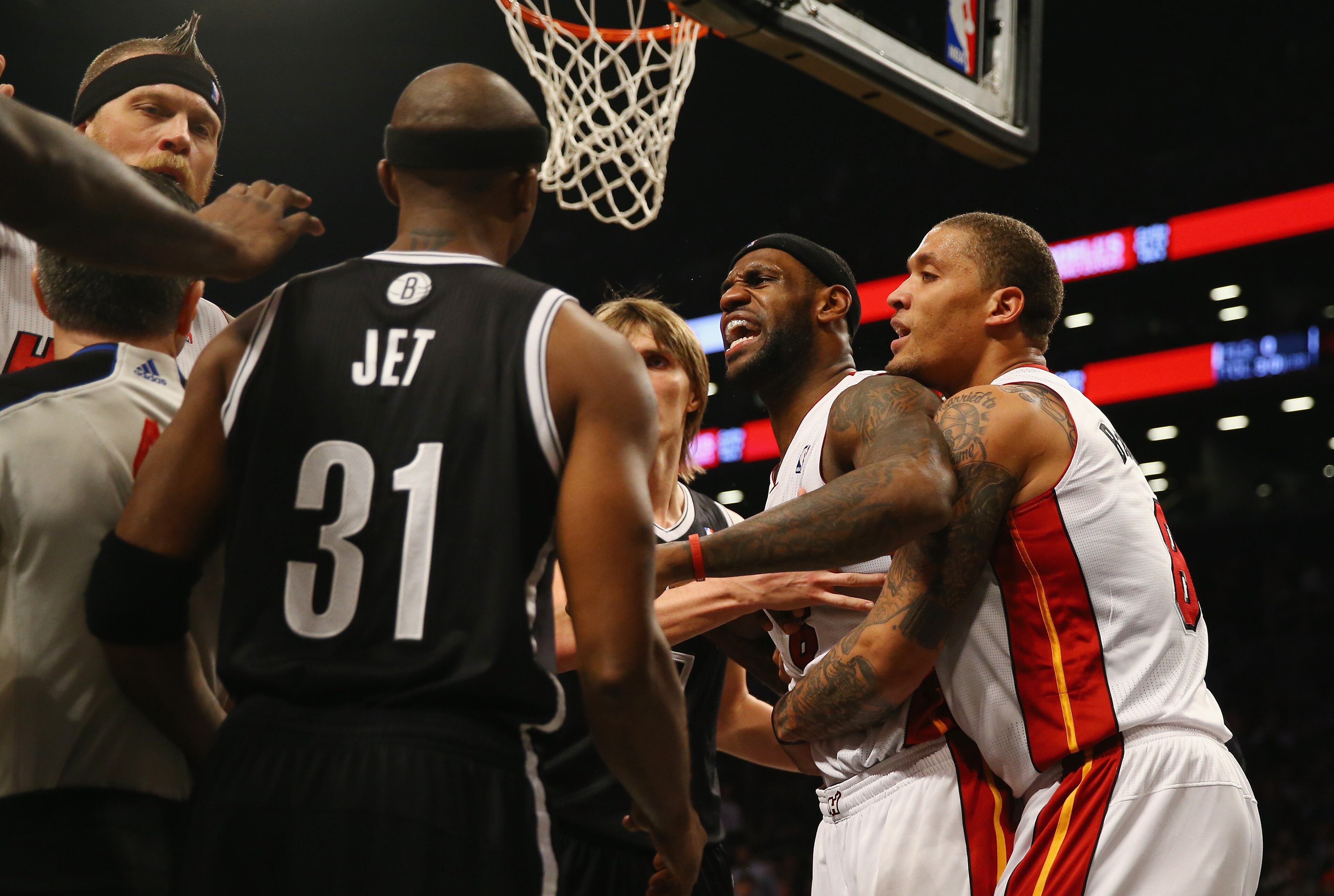 LeBron James #6 of the Miami Heat goes after Mirza Teletovic #33 of the Brooklyn Nets after he was fouled during their game at the Barclays Center on January 10, 2014 in New York City. N