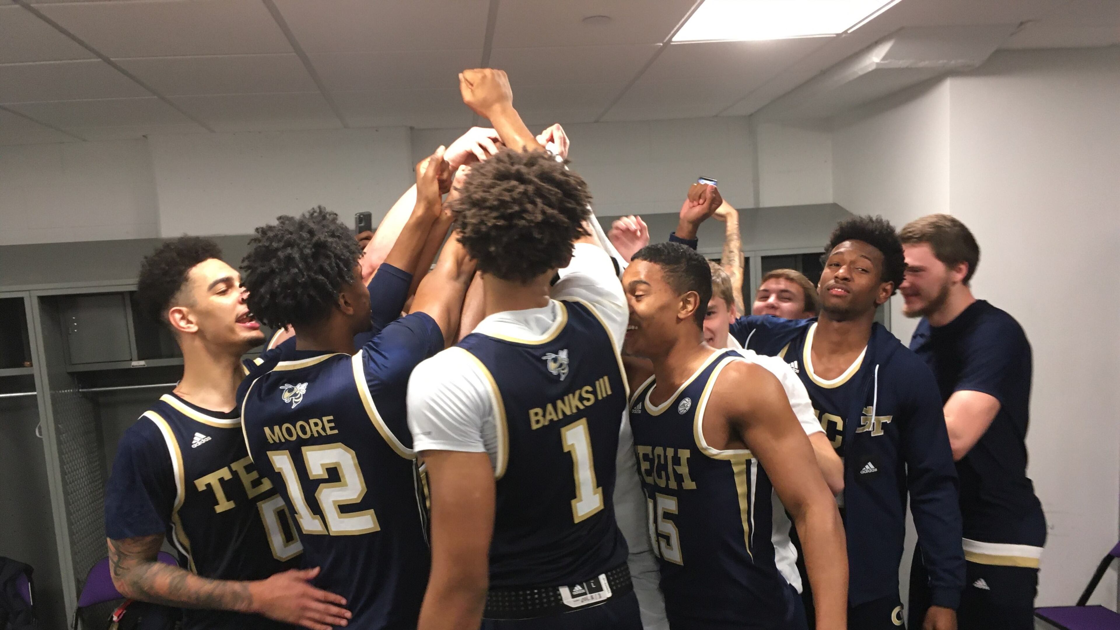 Georgia Tech players gather in a huddle in the locker room following the Yellow Jackets' win over Clemson March 7, 2020, in Clemson, S.C. (Ken Sugiura/AJC)