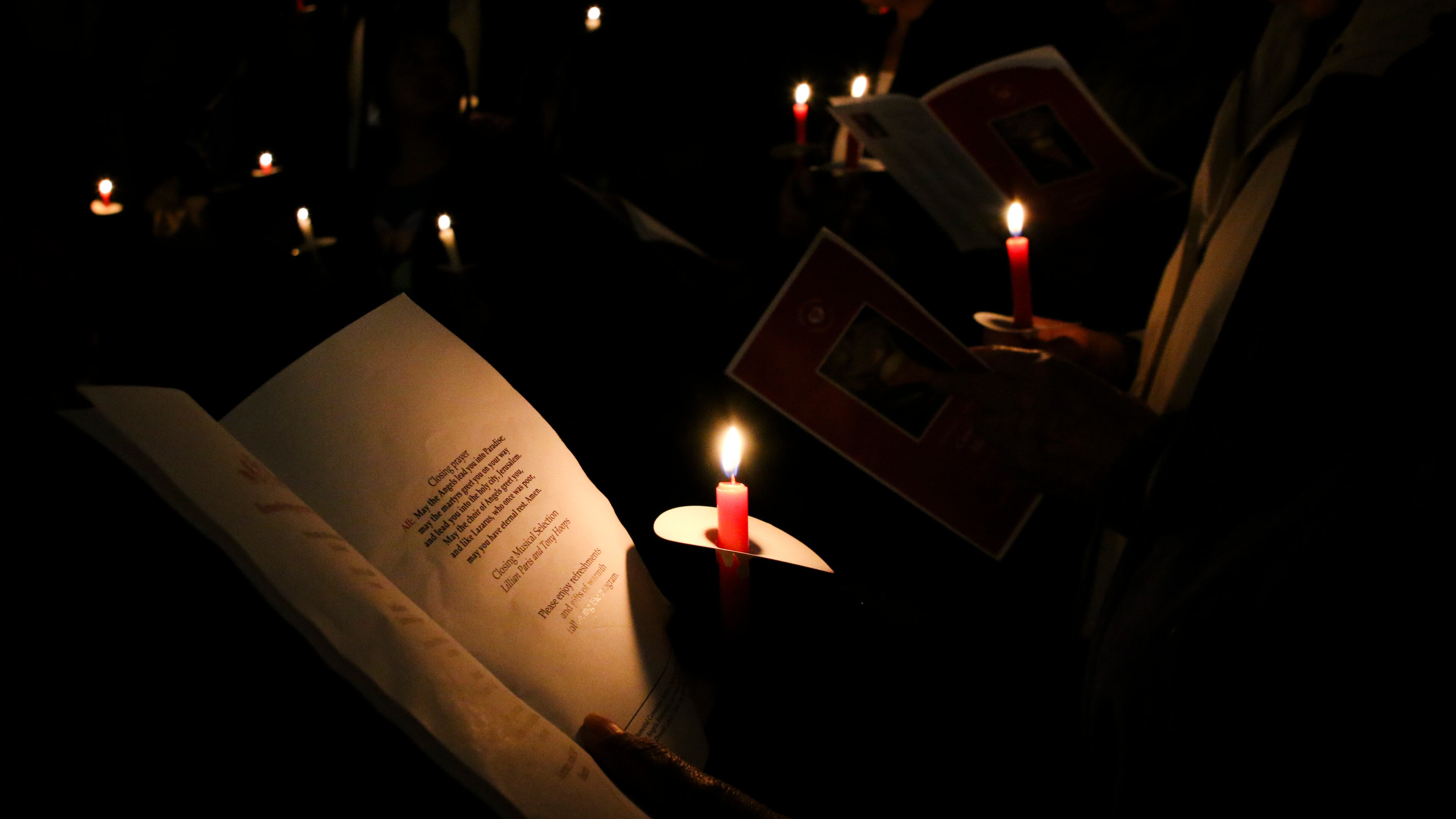 Commemorators hold candles and read the name of people who died while homeless at a 2019 vigil hosted by Mercy Care, an affordable health center in Atlanta. Mercy Care will hold its 16th annual vigil on Dec. 21 to mark National Homeless Persons Memorial Day, which began in 1990 by the National Coalition for the Homeless and the National Health Care for the Homeless Council.
