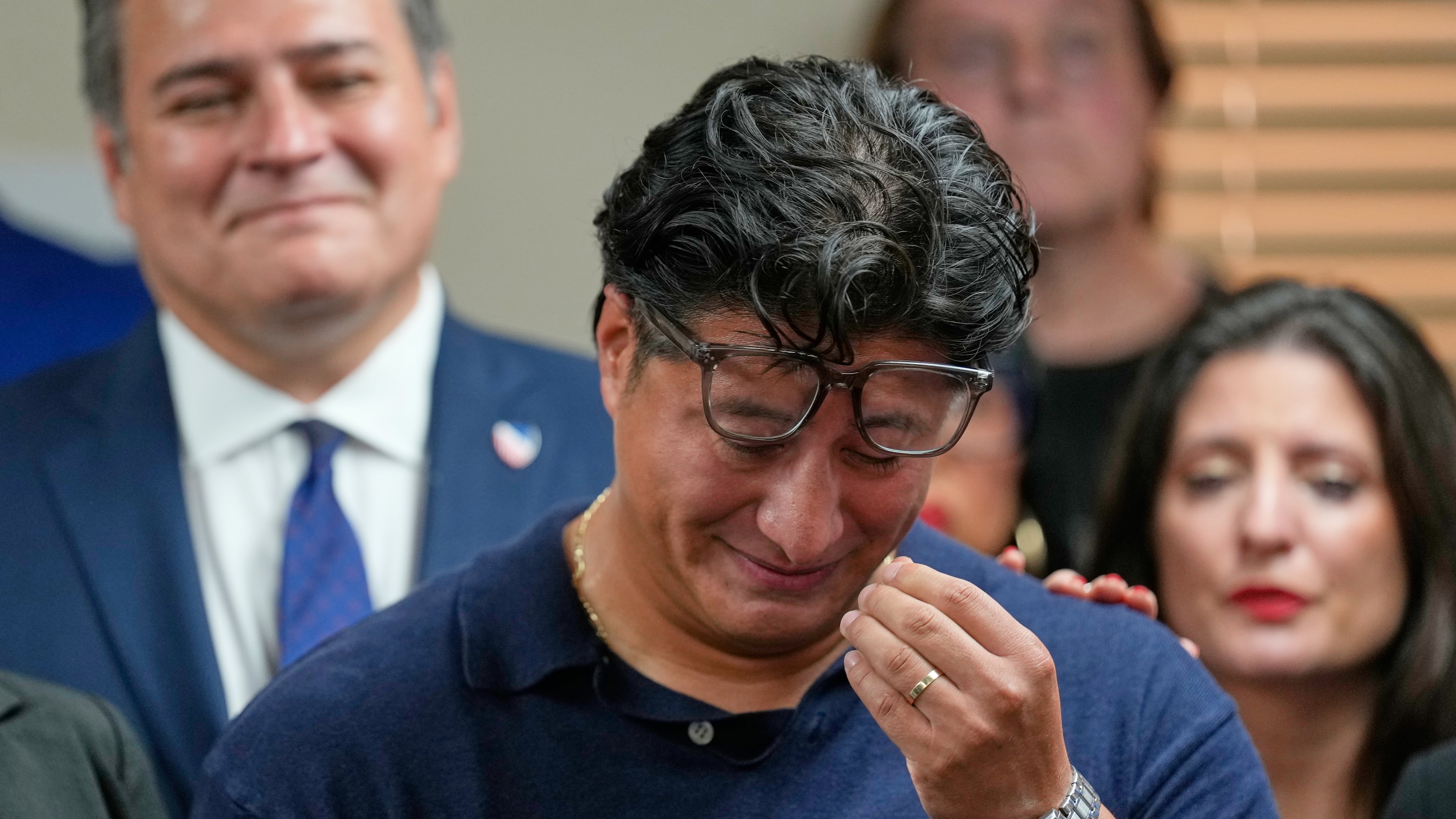 Ronaldo Salgado, son of Lorenzo Salgado Araujo, wipes away tears while speaking during a news conference Wednesday, July 8, 2026, in Houston. (AP Photo/David J. Phillip)