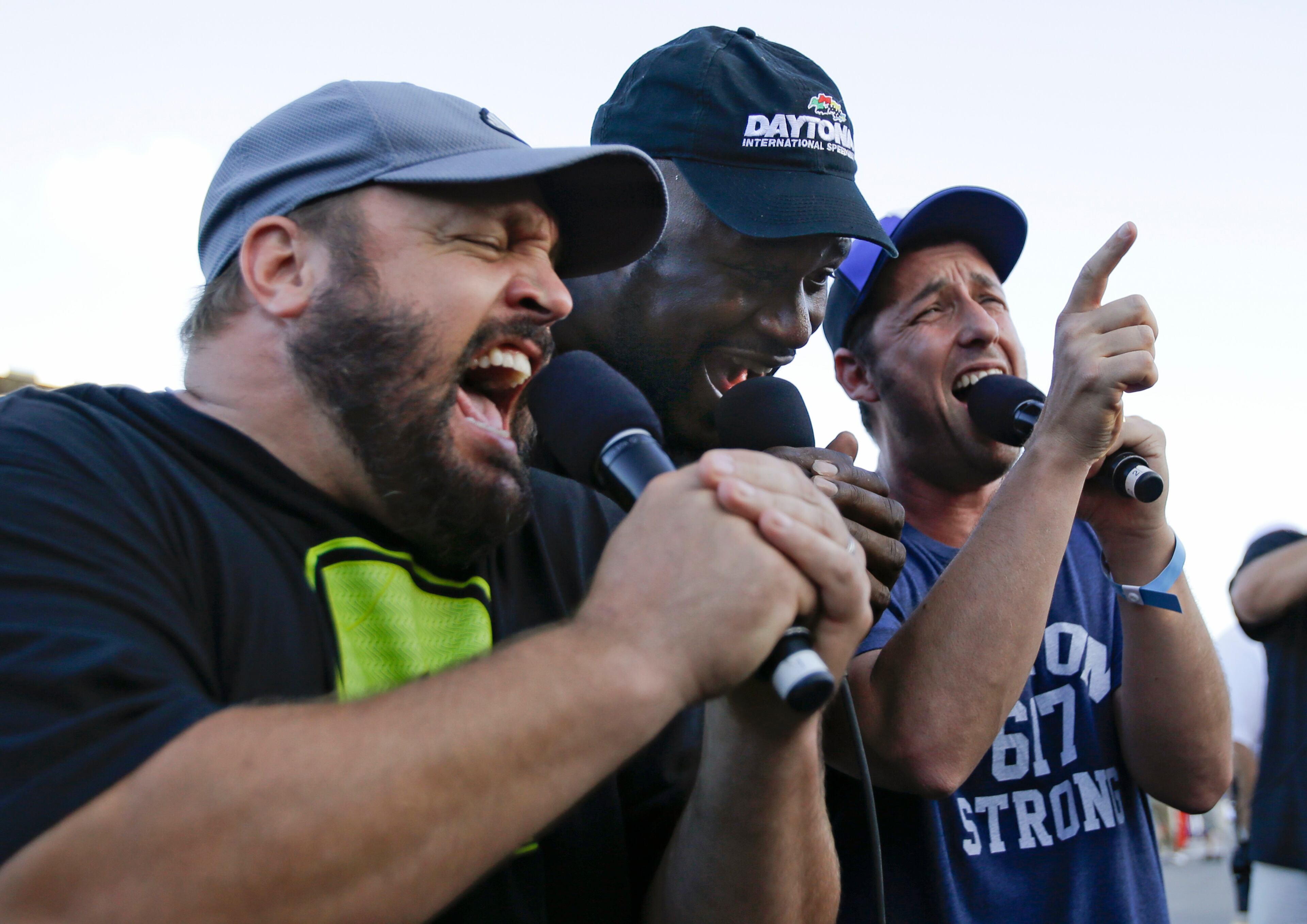 Kevin James, left, former NBA star Shaquille O'Neal and Adam Sandler, right, give the command to start engines for the NASCAR Sprint Cup auto race at Daytona International Speedway, Saturday, July 6, 2013, in Daytona Beach, Fla. The three are grand marshals for the race. (AP Photo/John Raoux)