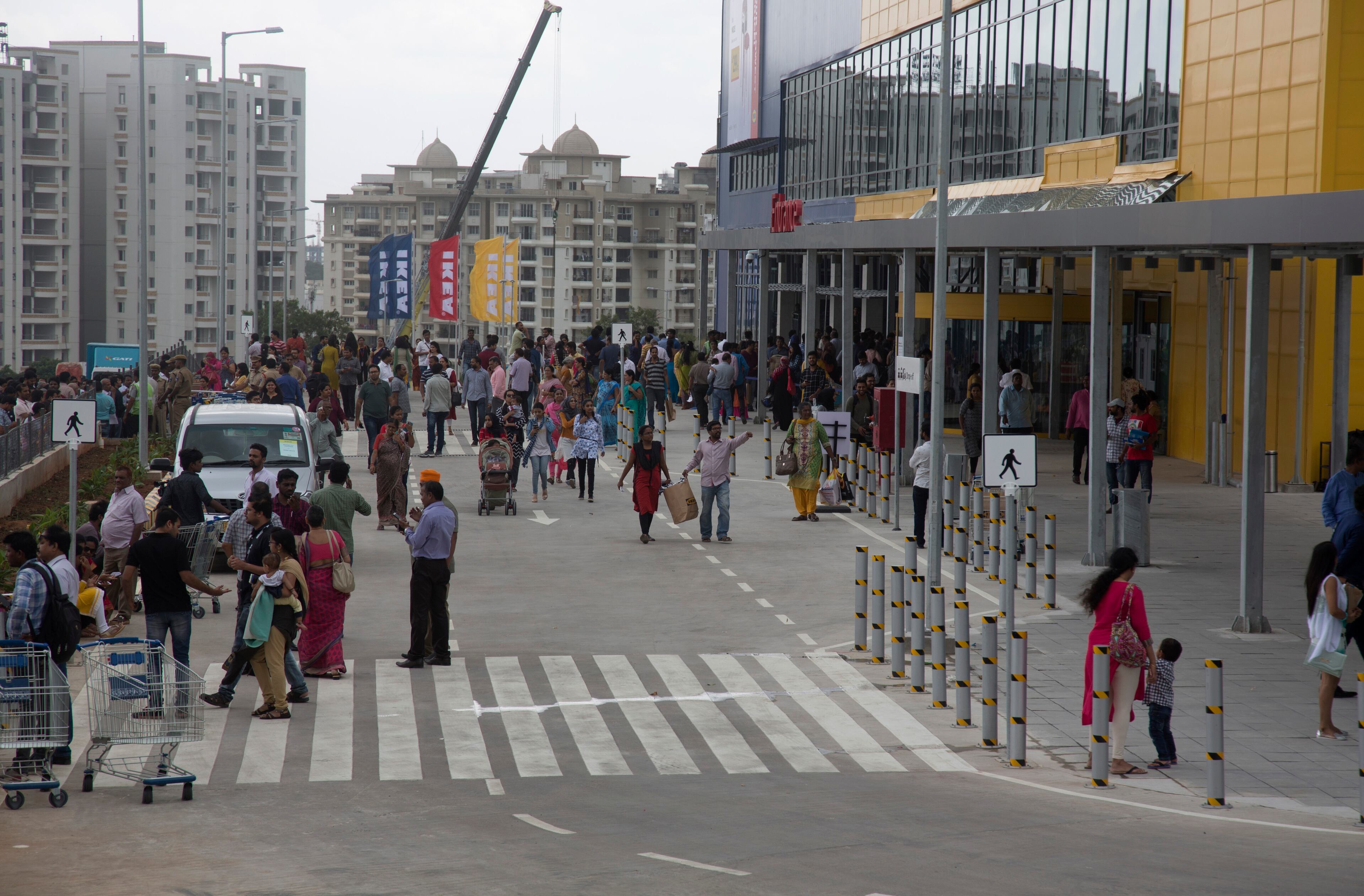 Indian customers stand outside IKEA's first store in India as it opened in Hyderabad, India, Thursday, Aug.9, 2018. Swedish home furnishings giant IKEA opened its first store in India on Thursday, five years after it received approval to invest in the country's single-brand retail sector. (AP Photo/Mahesh Kumar A.)