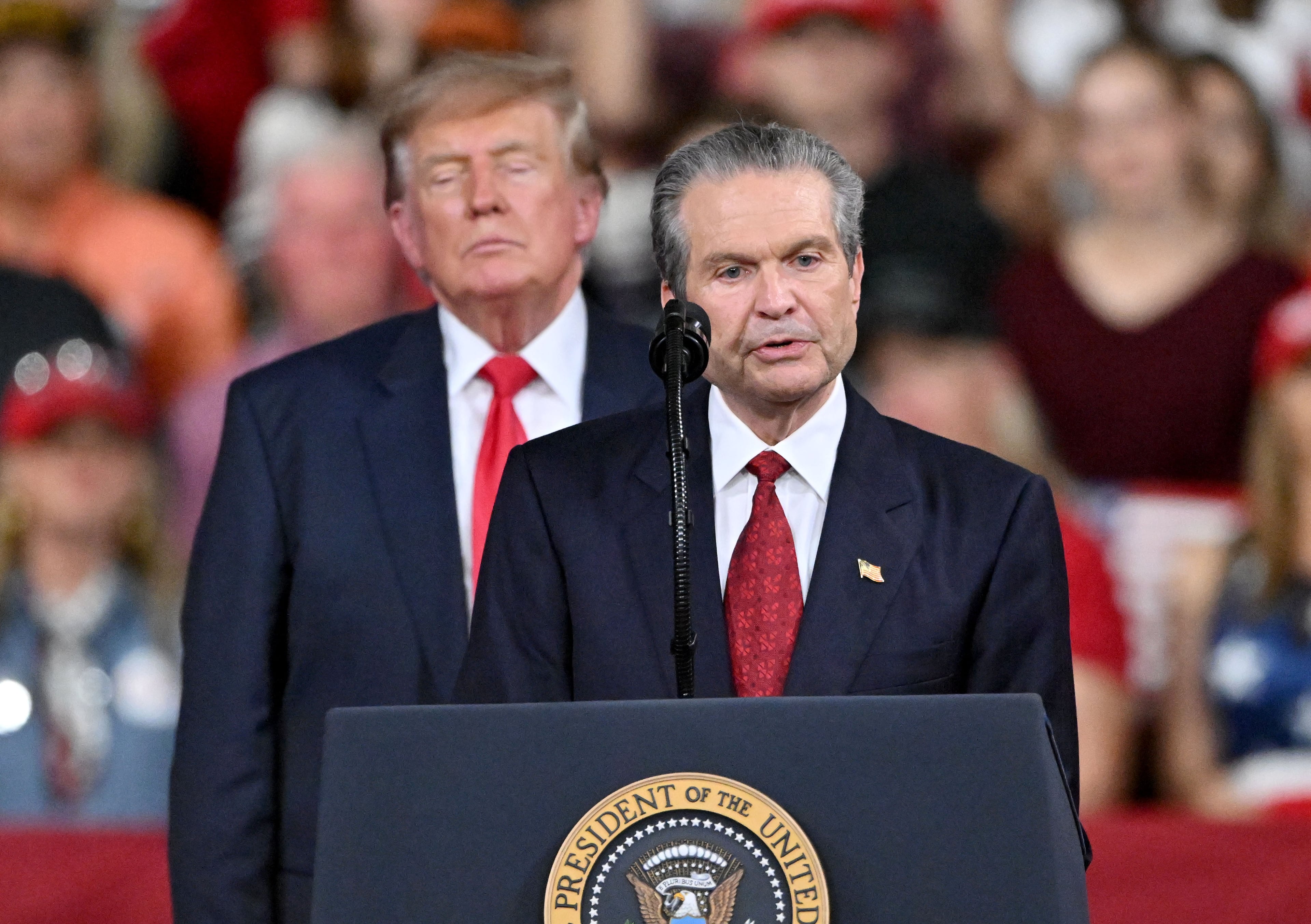 Georgia Republican nominee for governor Rick Jackson speaks as President Donald Trump stands behind him during a midterm campaign rally at Guardian Centers on Saturday in Perry. (Hyosub Shin/AJC)