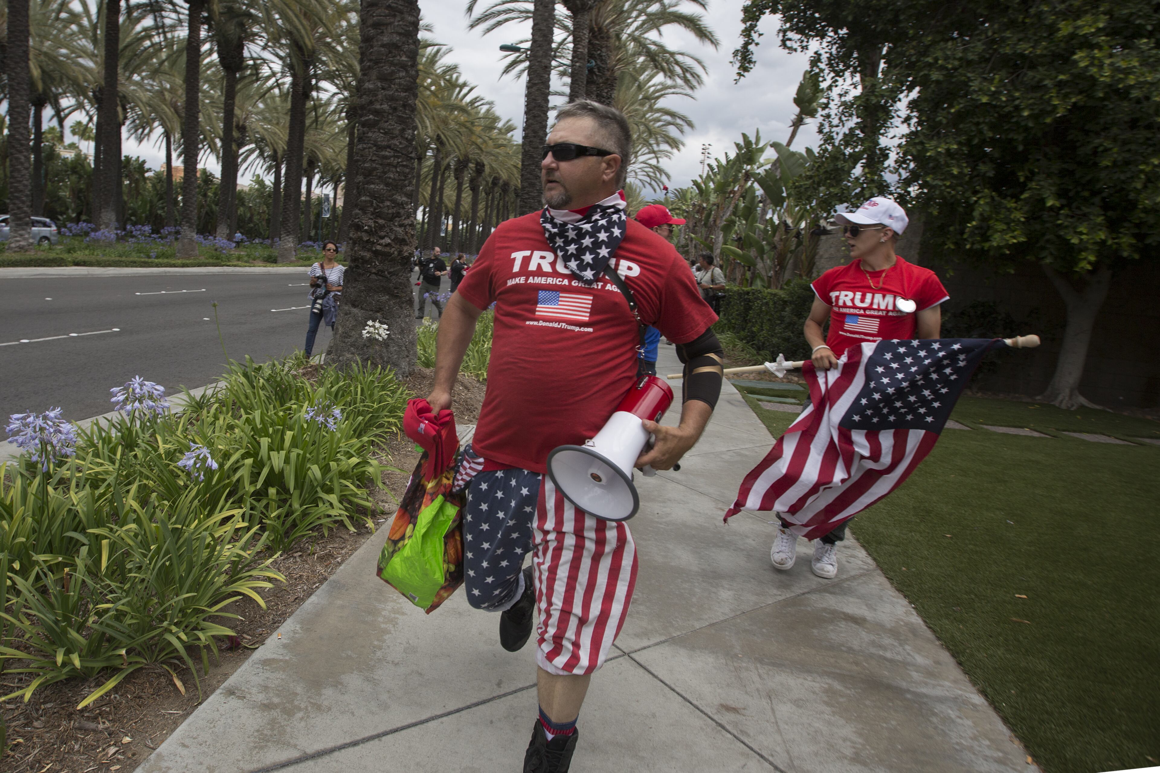 ANAHEIM, CA - MAY 25: Trump supporters run away from protesters near a campaign rally by presumptive GOP presidential candidate Donald Trump at the Anaheim Convention Center on May 25, 2016 in Anaheim, California. Previous visits by the candidate to Orange County have sparked in protests that resulted in some arrests. The presidential candidates are campaigning in Southern California for the June 7 California primary. (Photo by David McNew/Getty Images)