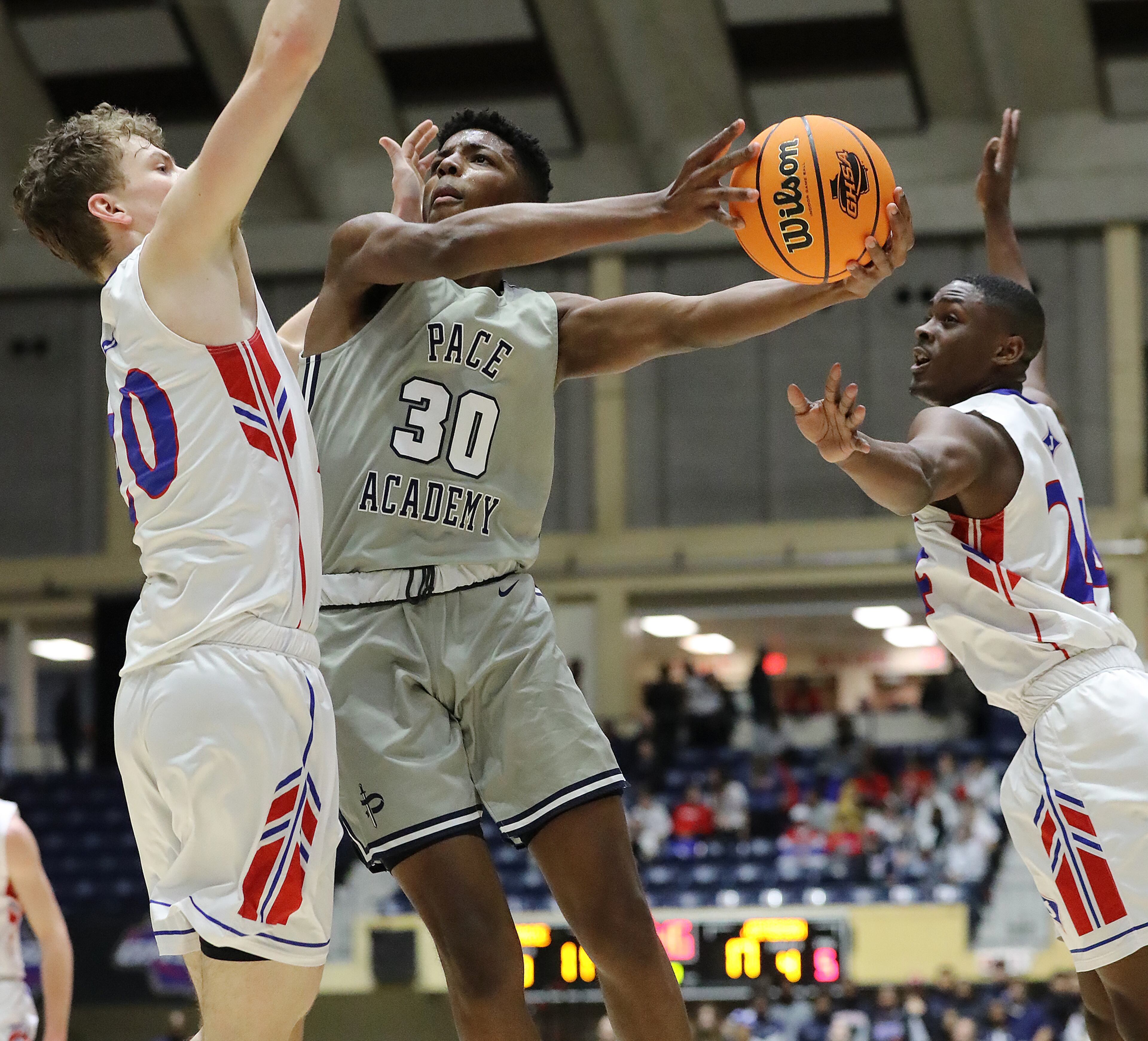 Pace Academy player Josh Reed is double teamed by Jefferson defenders Jacob Radaker (left) and Malaki Starks in the Class AAA boys state basketball championship on Thursday, March 5, 2020, in Macon. Curtis Compton ccompton@ajc.com