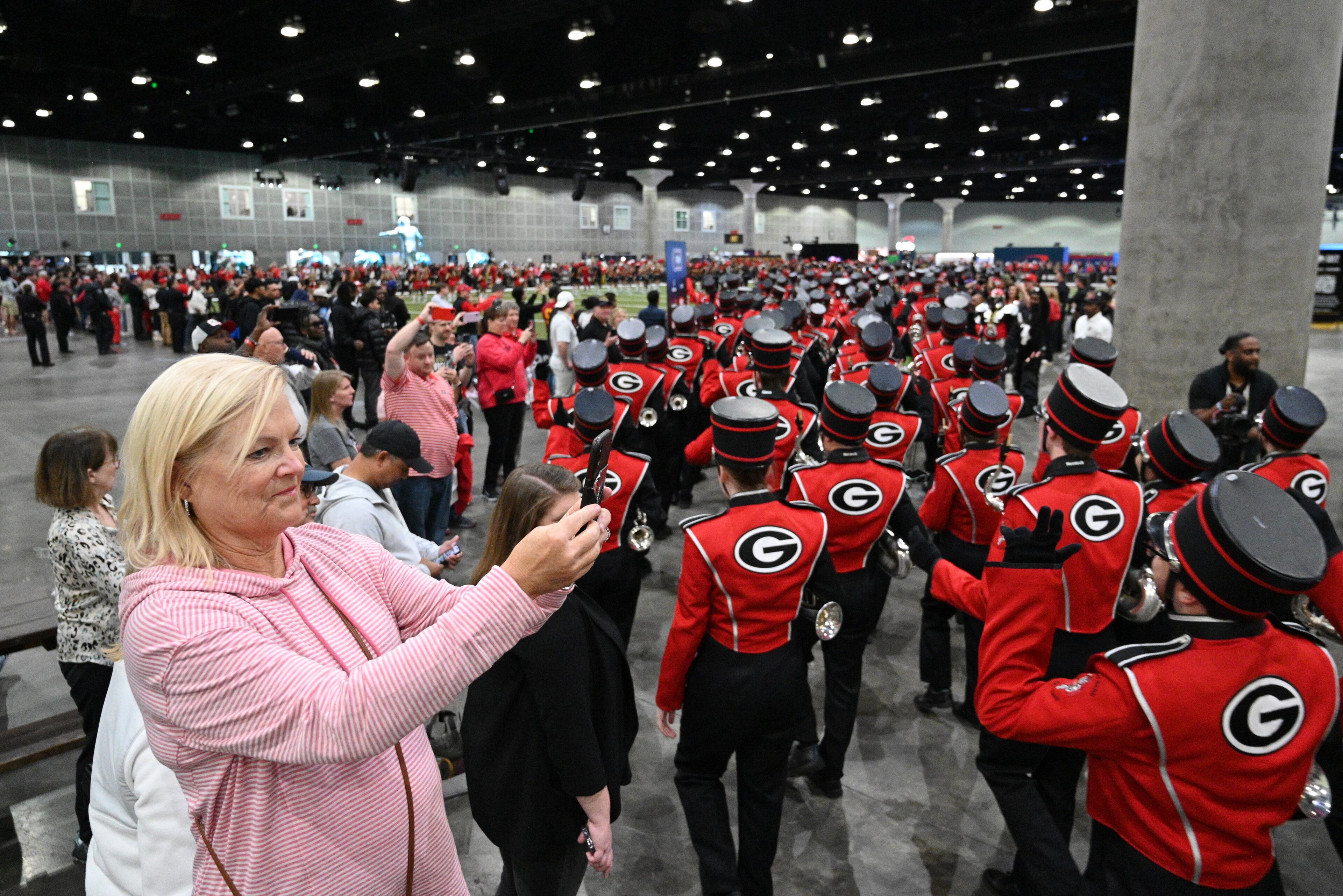 Hairy Dog and cheerleaders lead Georgia Redcoat Marching Band, and baton twirlers a during a pep rally at the Playoff Fan Central at the LA Convention Center, Sunday, Jan. 8, 2023, in Los Angeles. (Hyosub Shin / Hyosub.Shin@ajc.com)