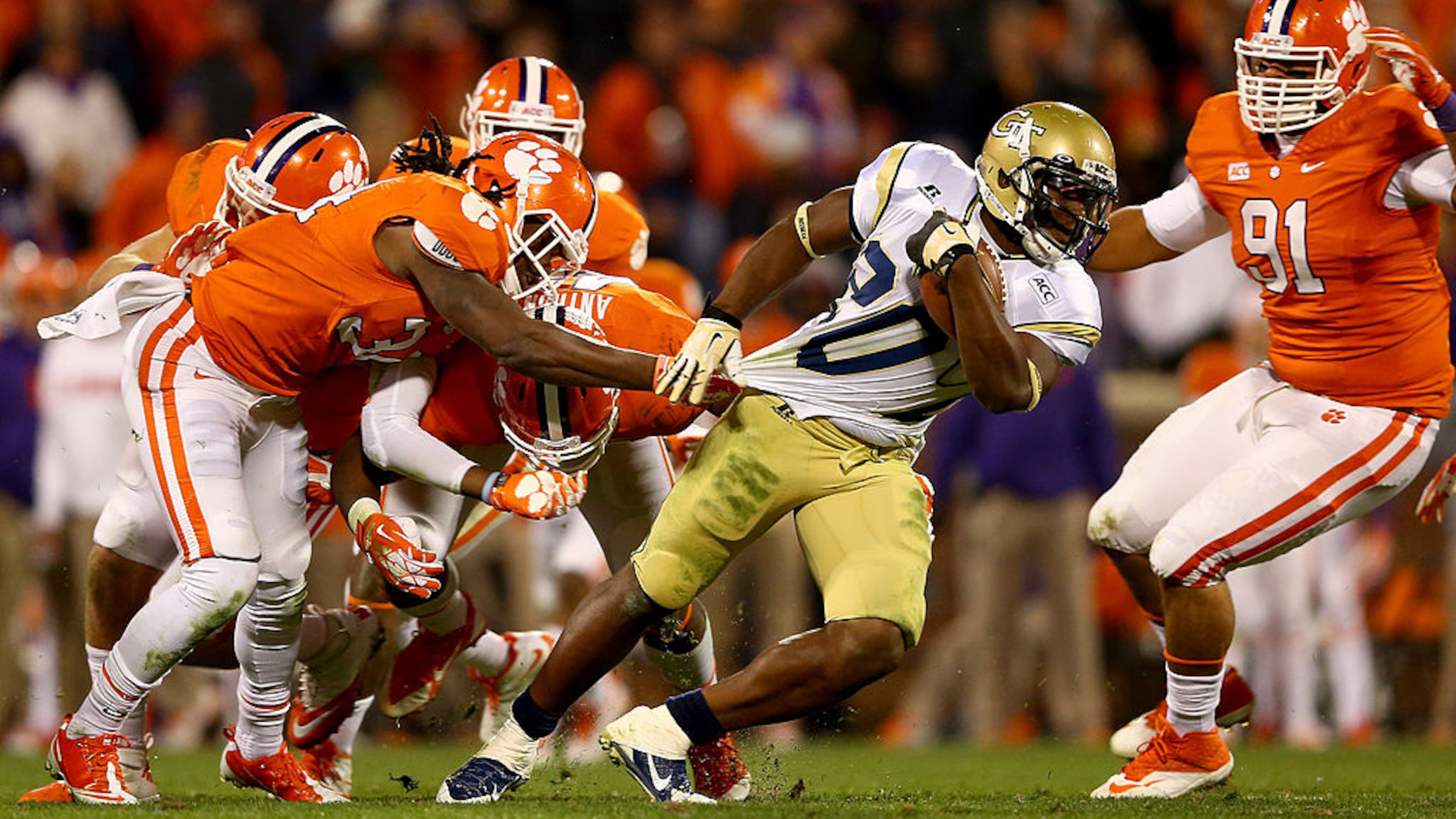 CLEMSON, SC - NOVEMBER 14: Quandon Christian #34 of the Clemson Tigers grabs the jersey of David Sims #20 of the Georgia Tech Yellow Jackets during their game at Clemson Memorial Stadium on November 14, 2013 in Clemson, South Carolina. (Photo by Streeter Lecka/Getty Images)