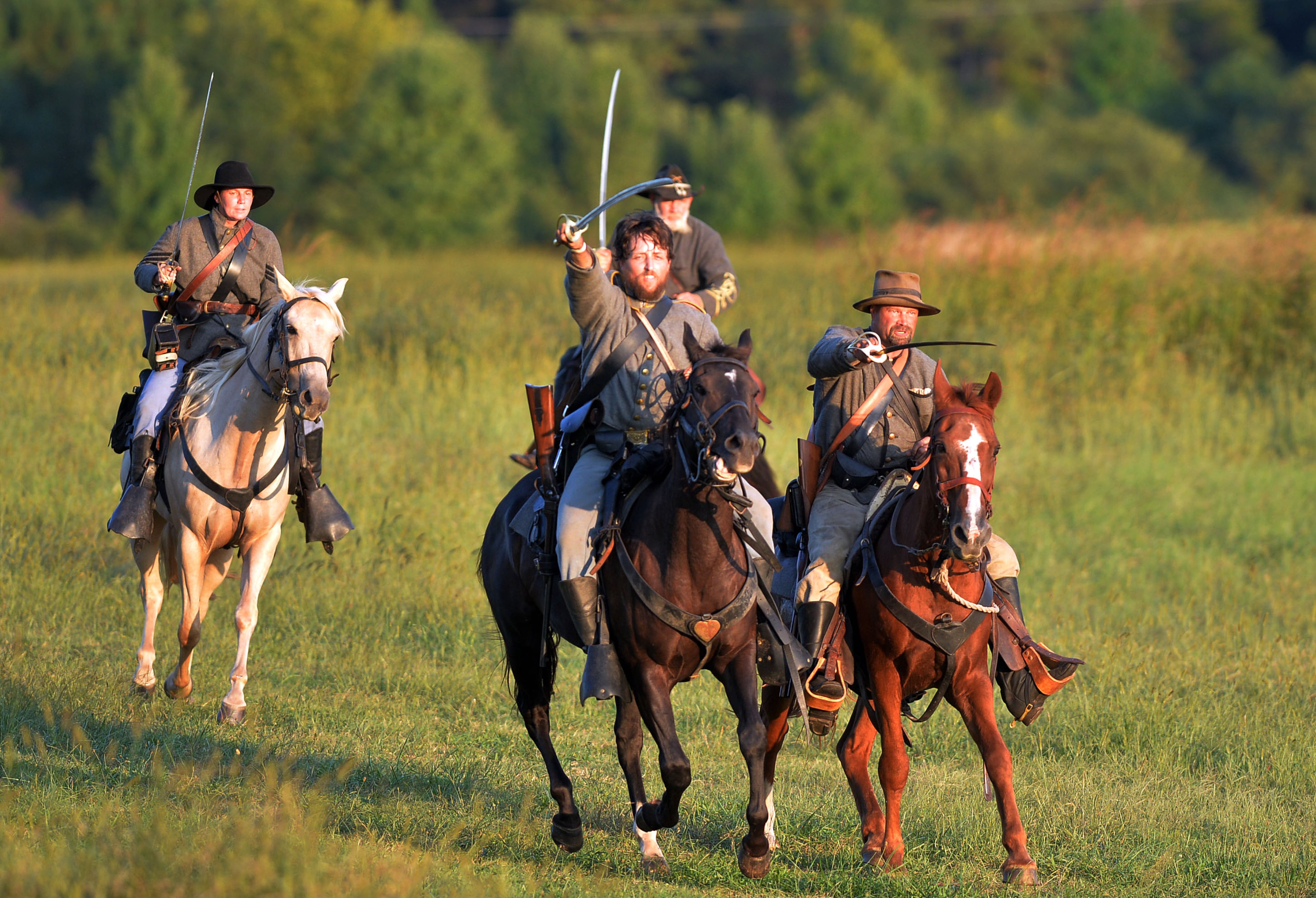 Confederate cavalry charges towards the Union lines. Confederate and Union reenactors recreate the Battle of Utoy Creek during the Atlanta Campaign's Battle of Atlanta re-enactment at the Nash Farm Battlefield Friday, September 19, 2014. Thousands of re-enactors and spectators are expected to descend on Nash Farm Battlefield for this weekend's Battle of Atlanta events starting Friday and ending Sunday afternoon. Kilpatrick's Raid, the Battle of Cheatham's Hill, and Battle of Atlanta will be reenacted Saturday and Sunday. Confederate and Federal troops are in separate encampments about a 1/2 mile apart at the site. KENT D. JOHNSON / KDJOHNSON@AJC.COM
